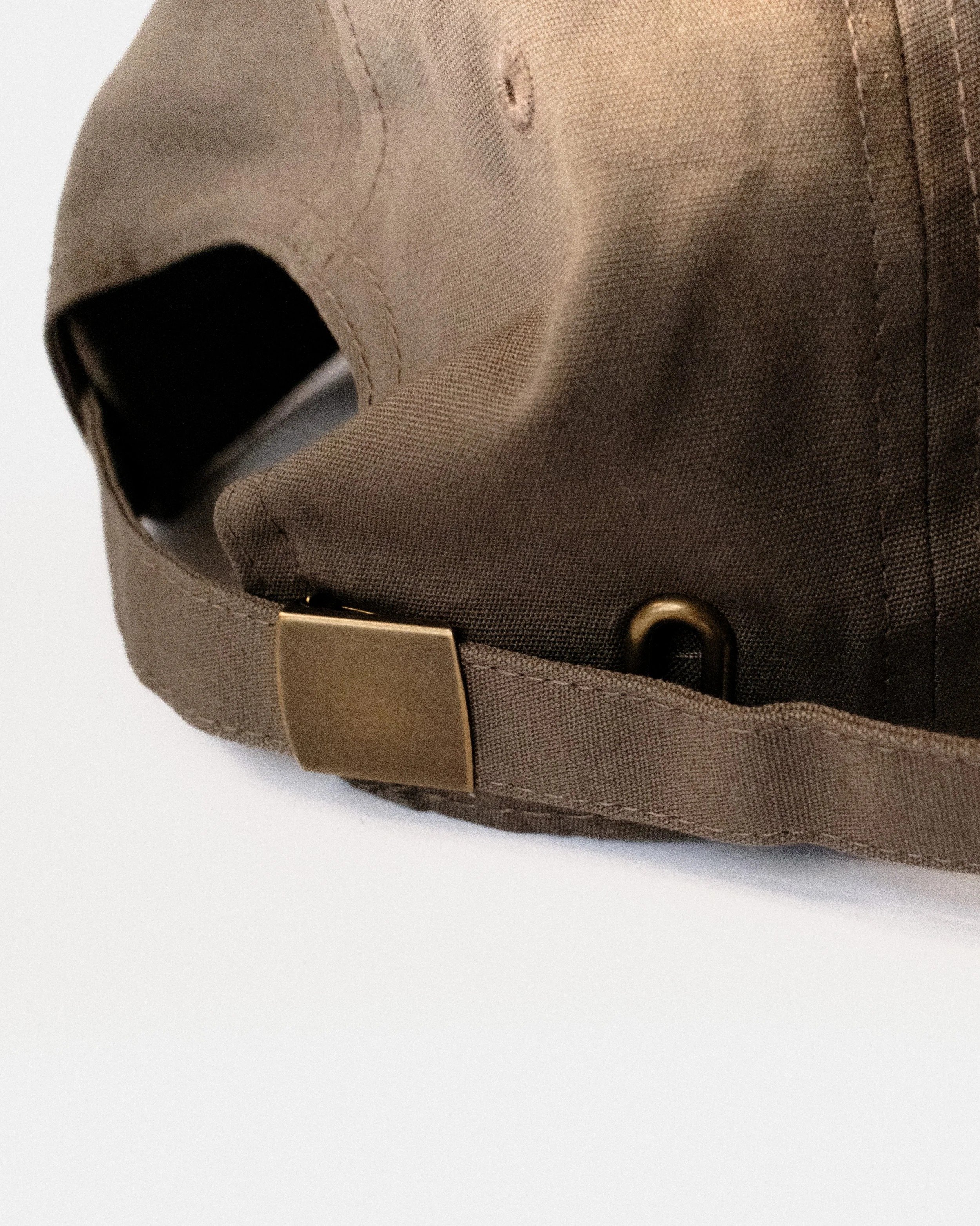 Brown and yellow Just Out For A Walk dad hat, back view with adjustable metal clasp