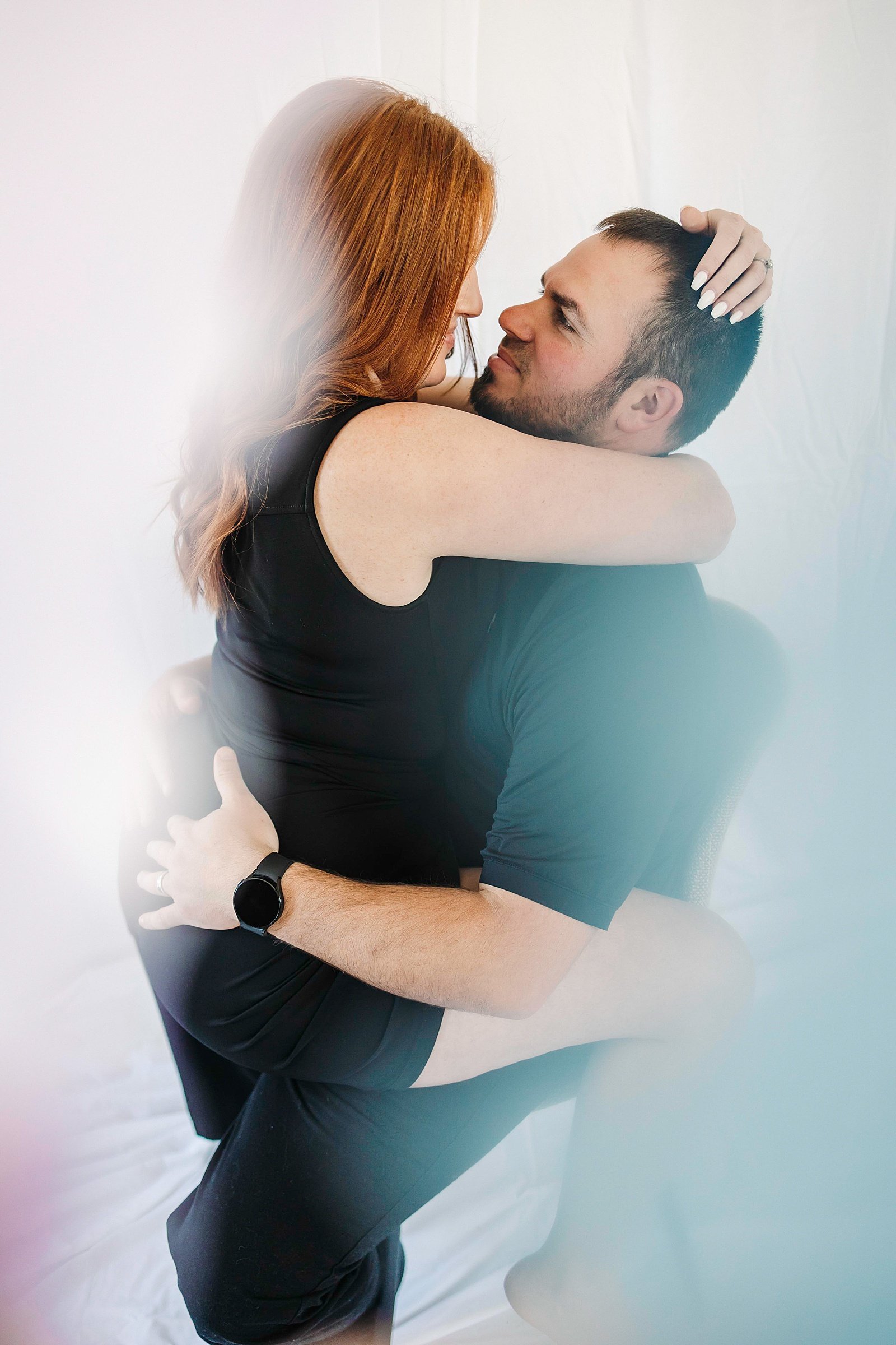  Woman and man curled up together by Minneapolis couples photographer McKenzie Berquam  