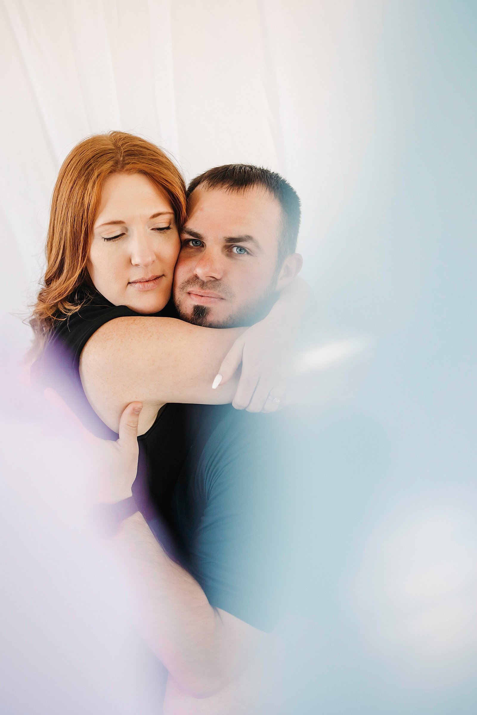  Woman and man hugging at a photo studio by Mckenzie Berquam 