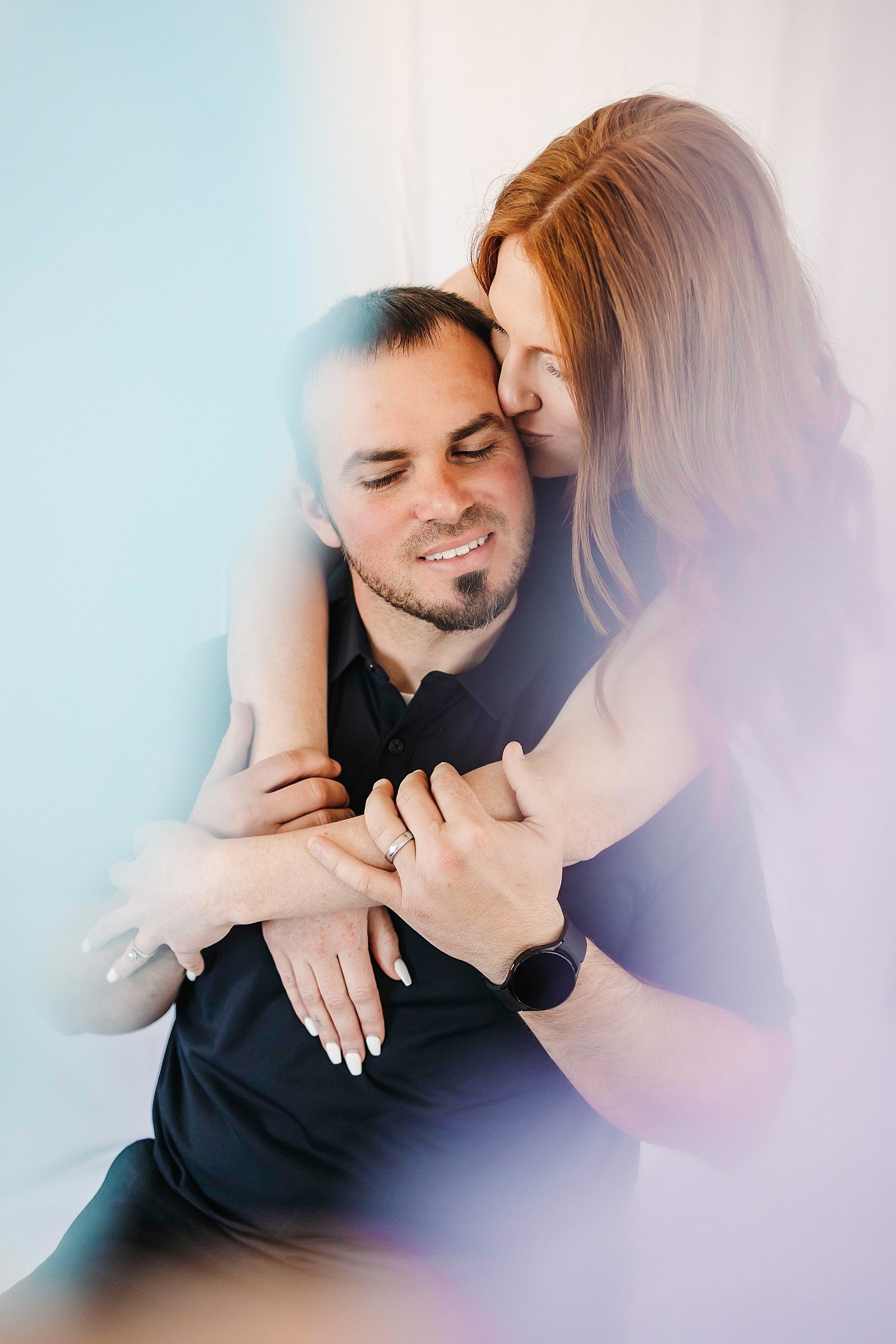  Woman wrapping up man in a hug by Minnesota couples photographer McKenzie Berquam 