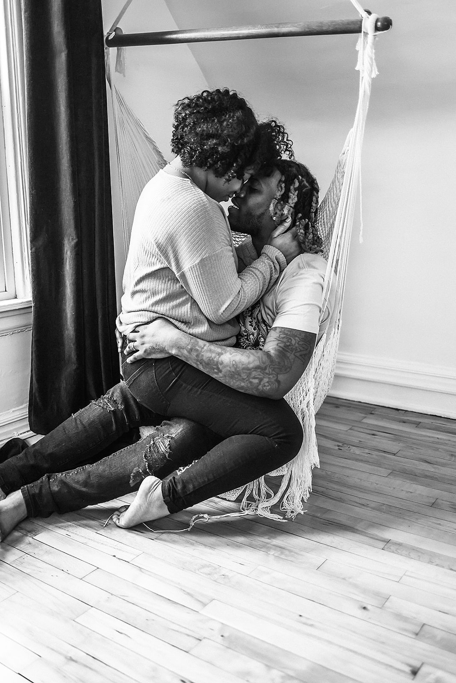  Couple sitting on the floor kissing for their Airbnb couples session 
