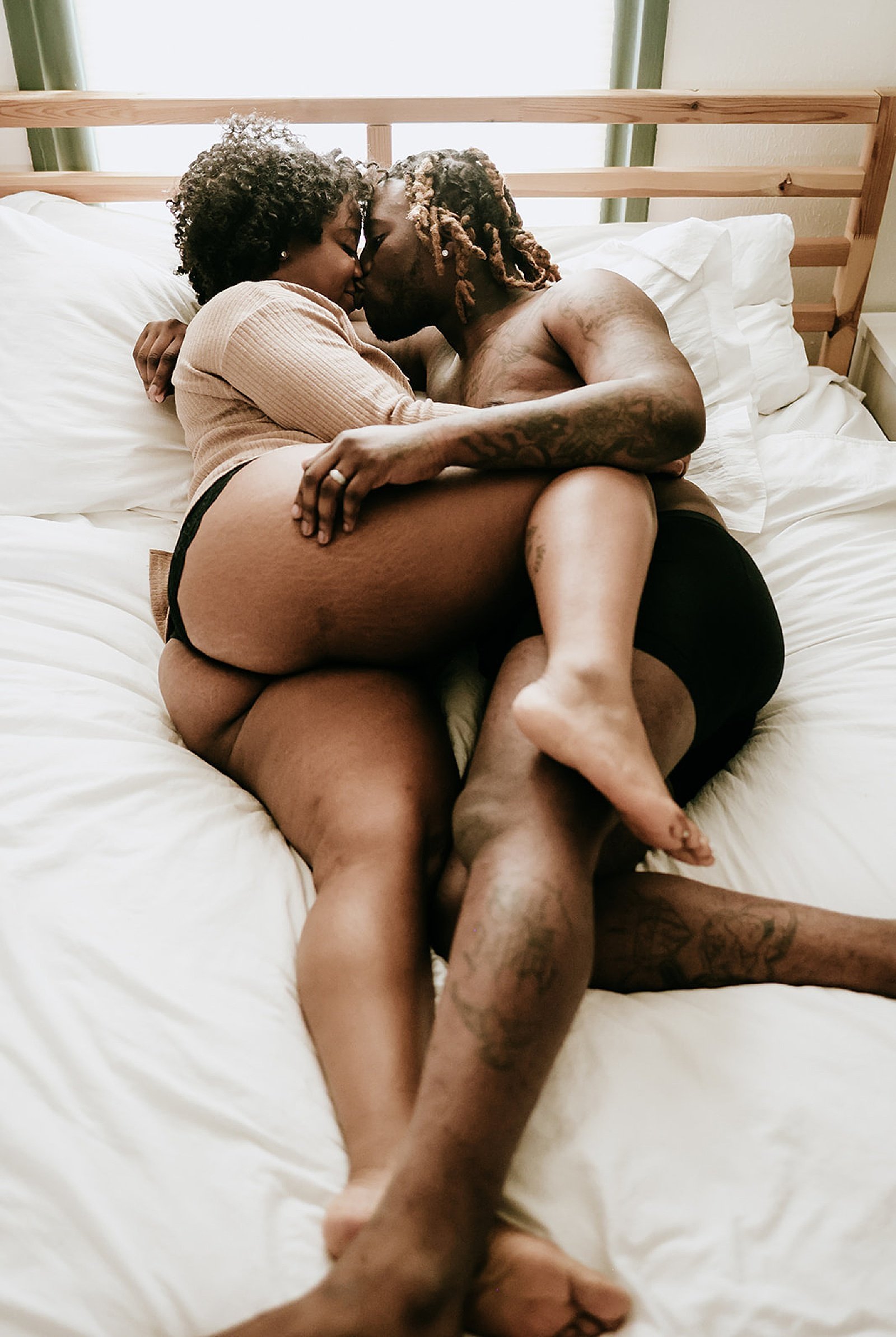  Man and woman half undressed in bed for airbnb couples session 