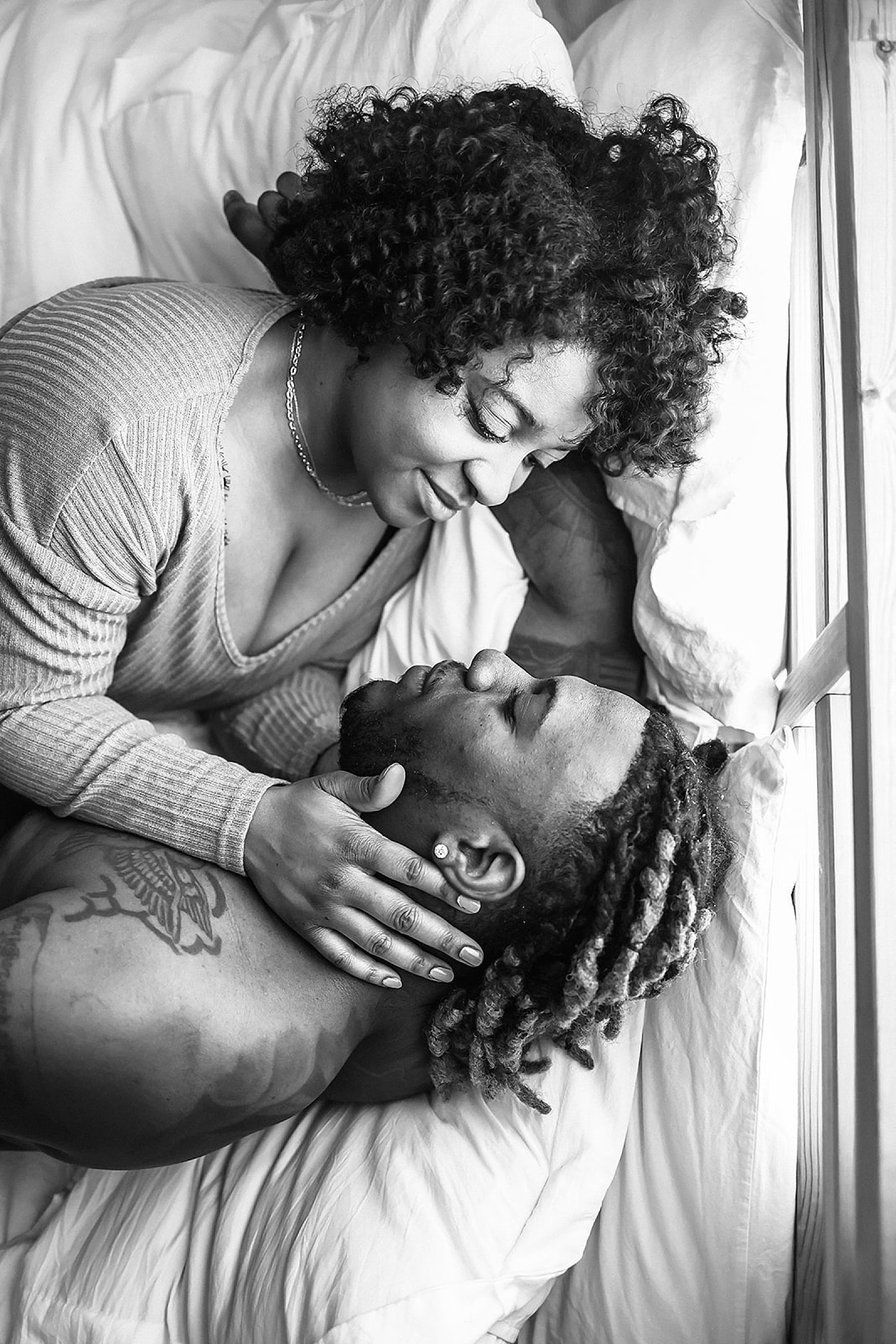  Couple embracing in bed by Minnesota engagement photographer 