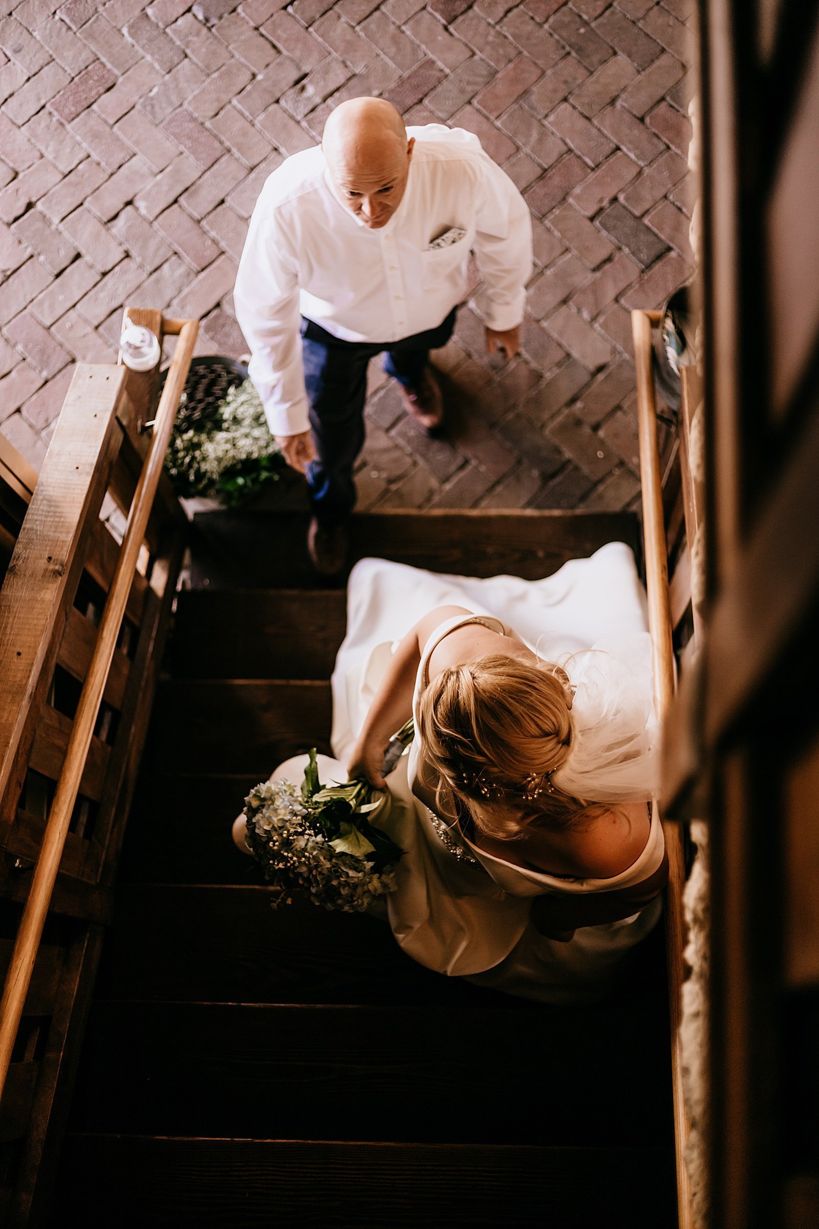  Bride entering a stairwell with her father to walk down the aisle at Mayowood Stone Barn 