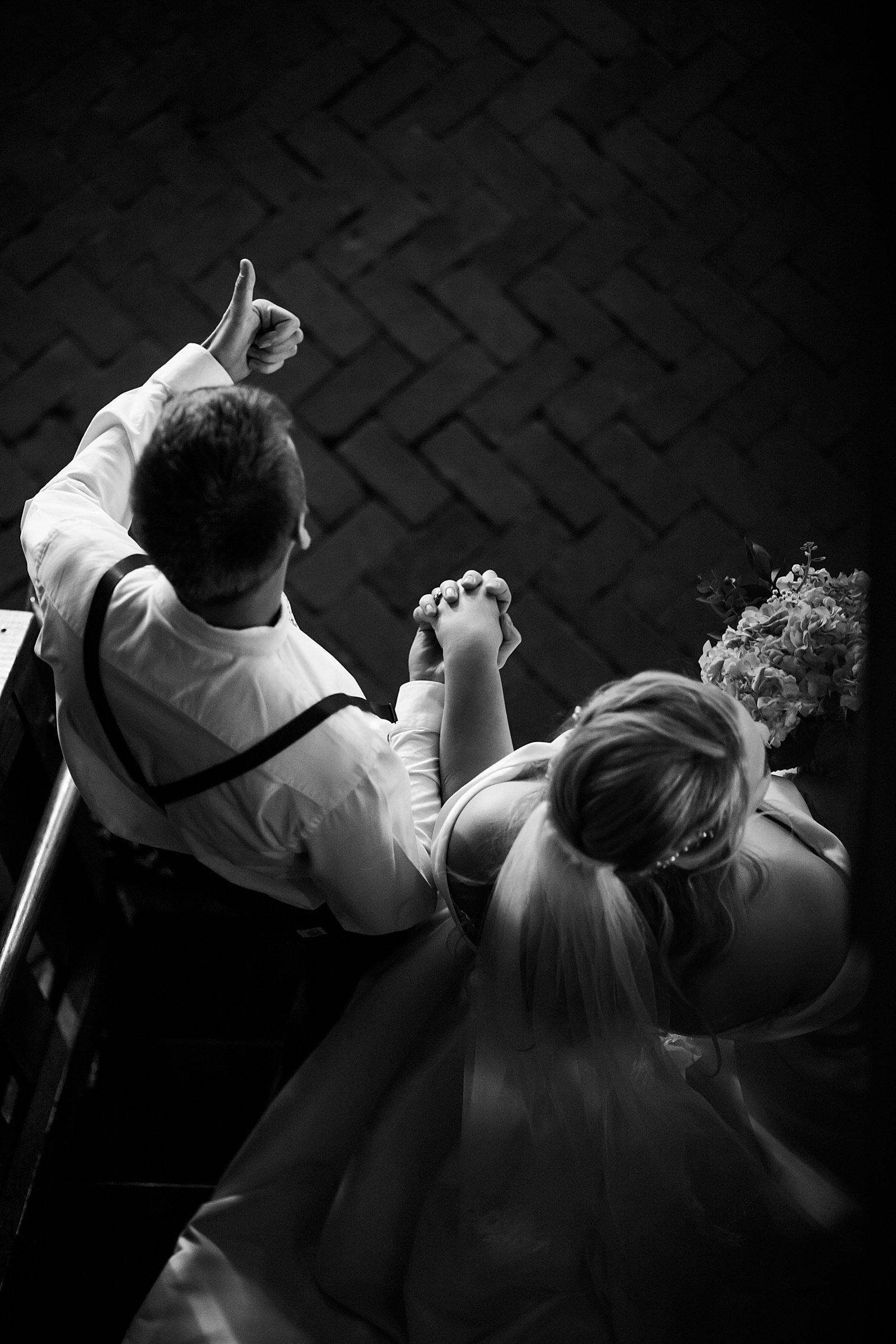  Newlyweds walking down a stair well together at Mayowood Stone Barn 