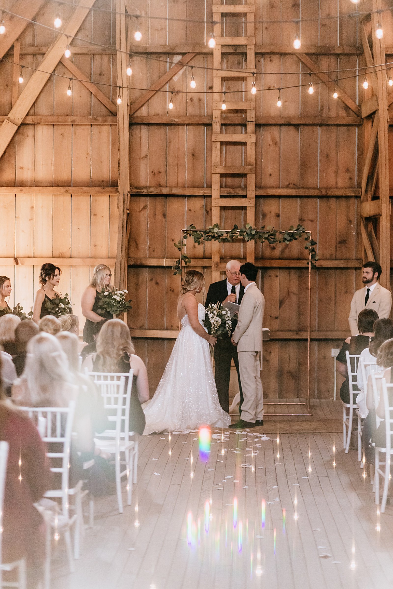  Newlyweds at the alter for their farmhouse wedding in Minnesota.  