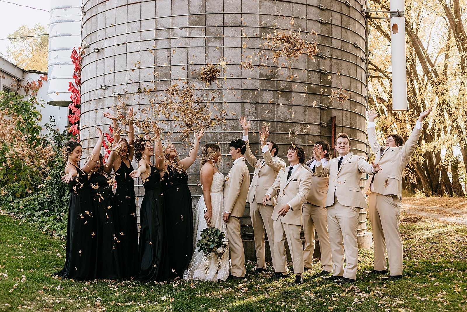  Large wedding party in Black and Tan in front of a silo at The Cottage Farmhouse in Minneapolis  