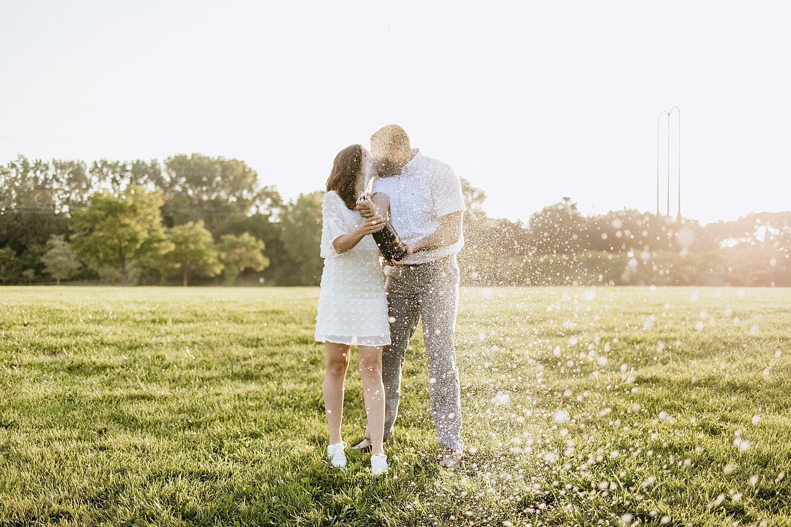  Couple pops champagne for their engagement session at Boom Island Park.  