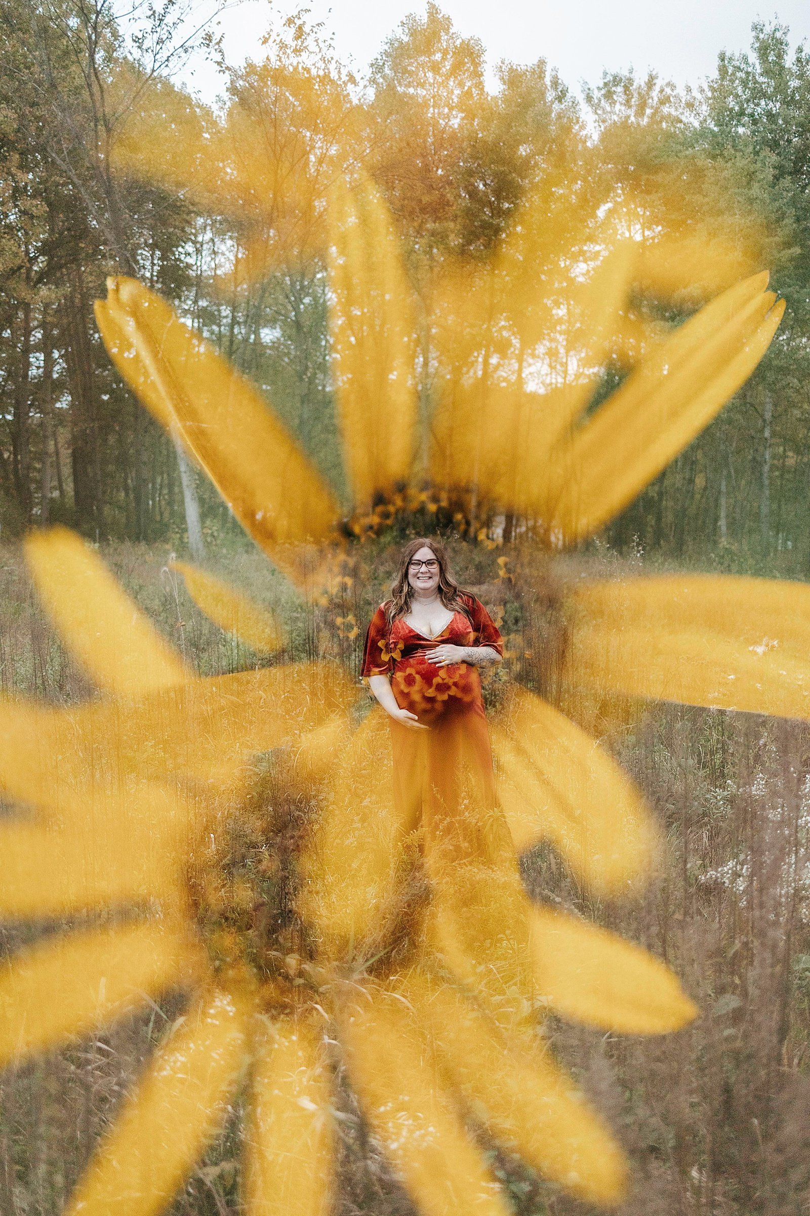  Pregnant lady in velvet wine colored dress with yellow flowers in Lebanon Hills Park. 