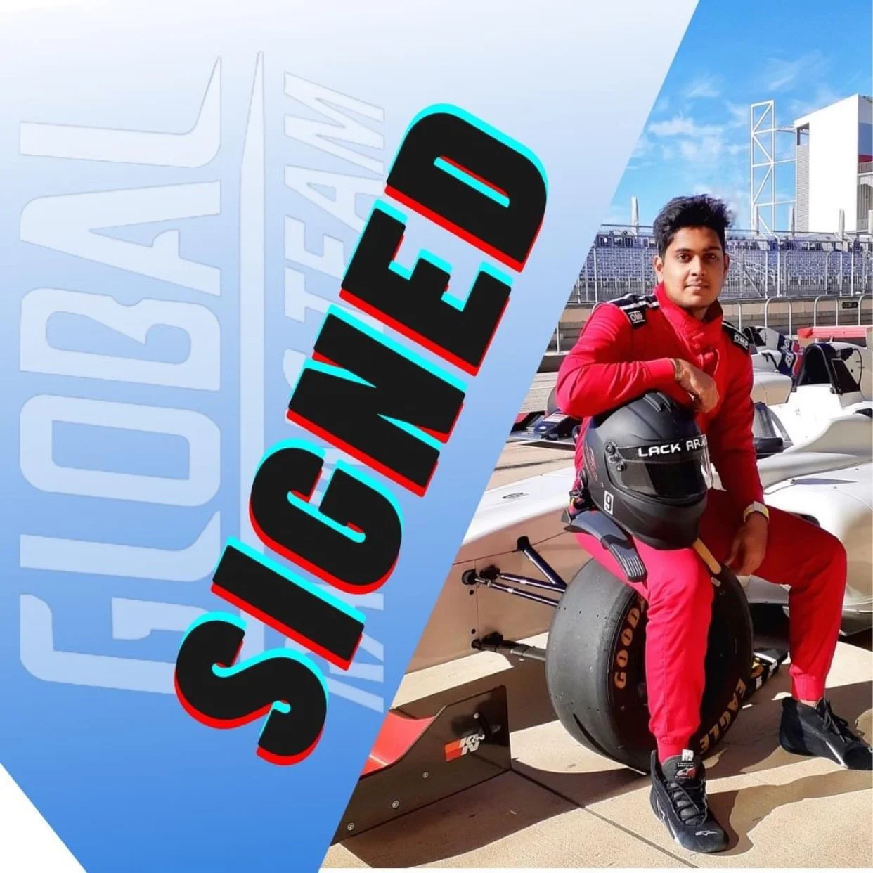 A person in a red racing suit sitting on a racing car with a helmet, at a race track under a blue sky with buildings in the background, with a large blue diagonal banner reading 'SIGNED' and 'OUT'.