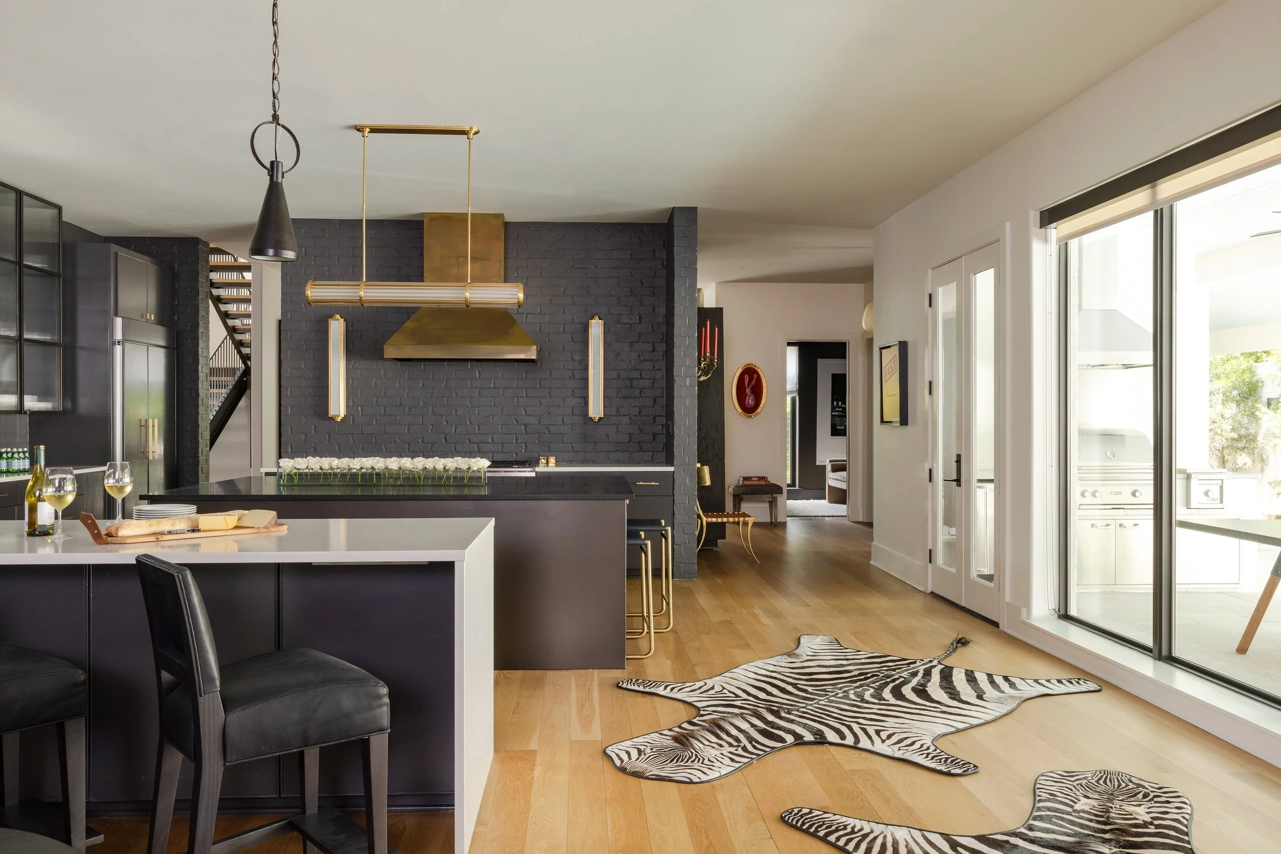 ty-larkins-interiors-baton-rouge-black-kitchen-brass-range-hood.jpg