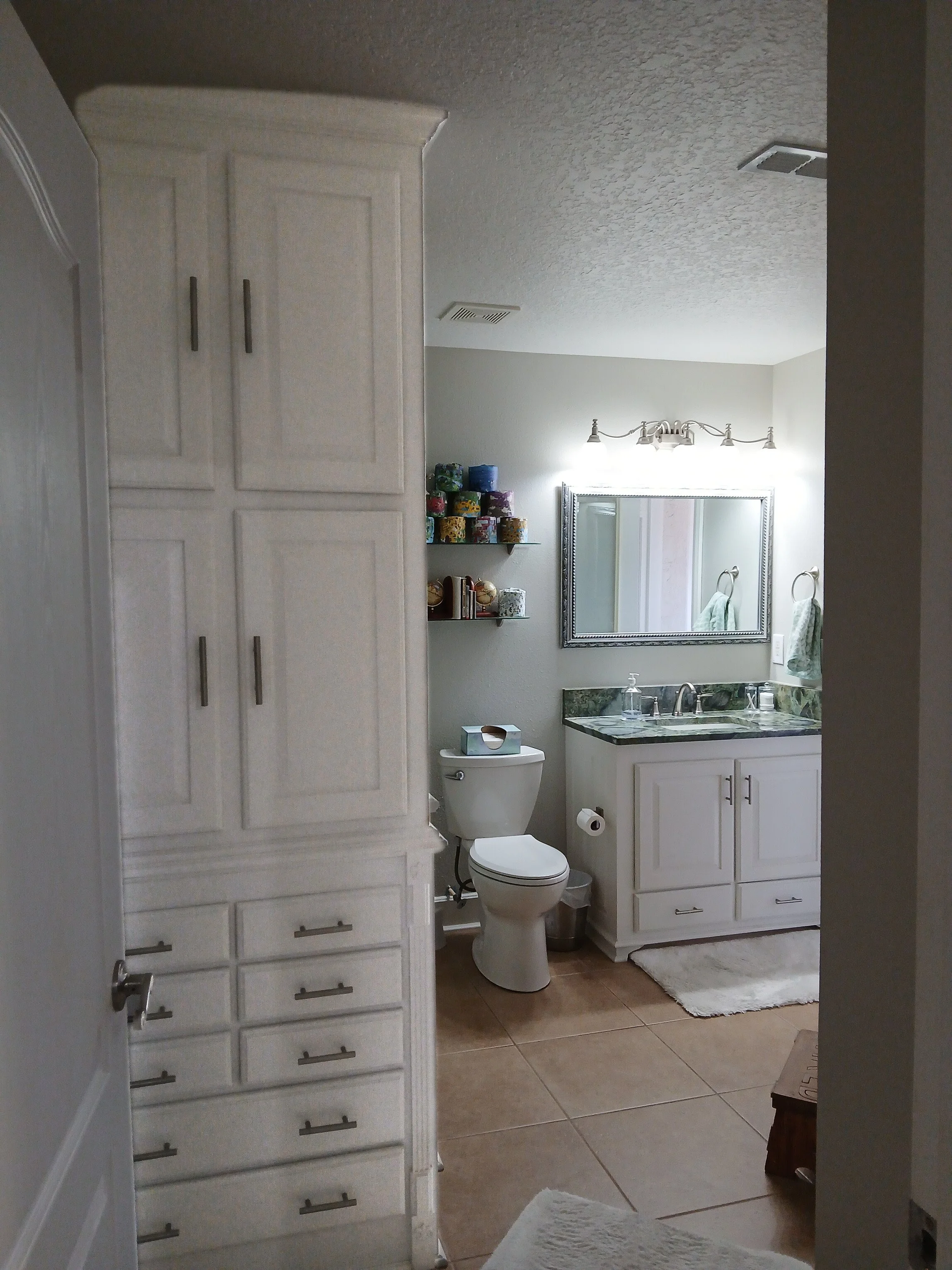 white shaker single bathroom with plenty of storage
