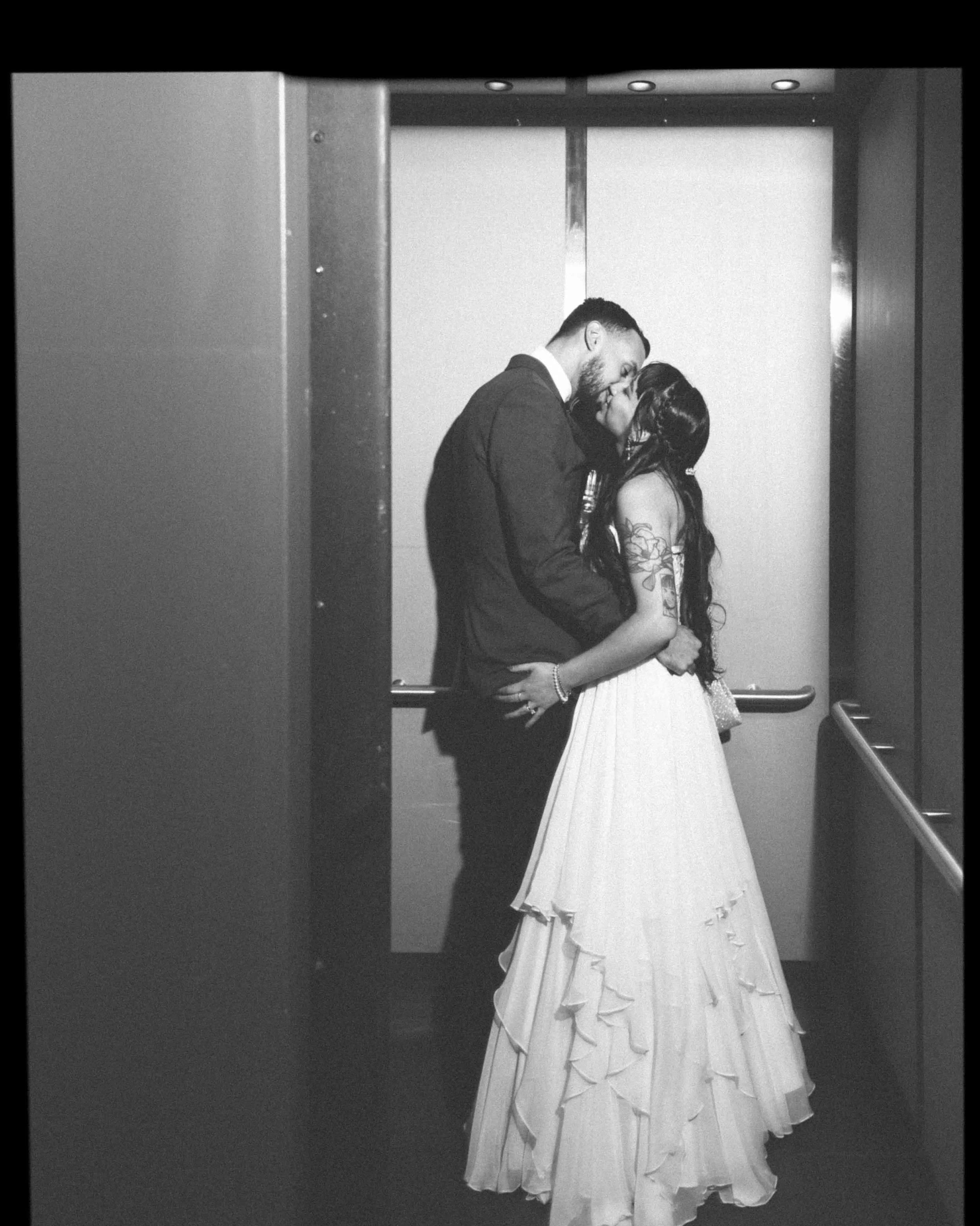 acqua-catering-events-wedding-elevator-kiss-1.jpg