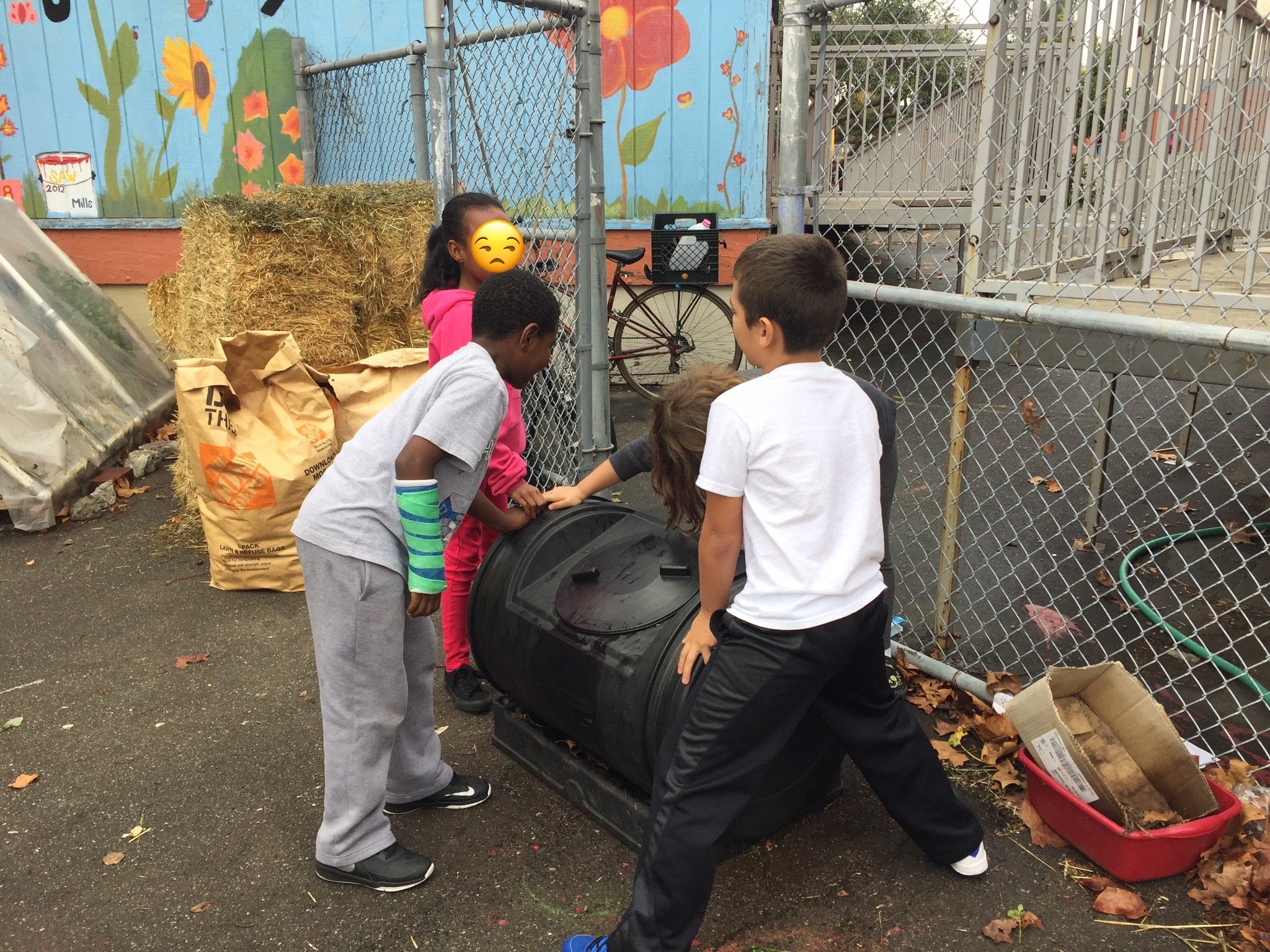 Students practice teamwork while spinning the compost bin. ~2014