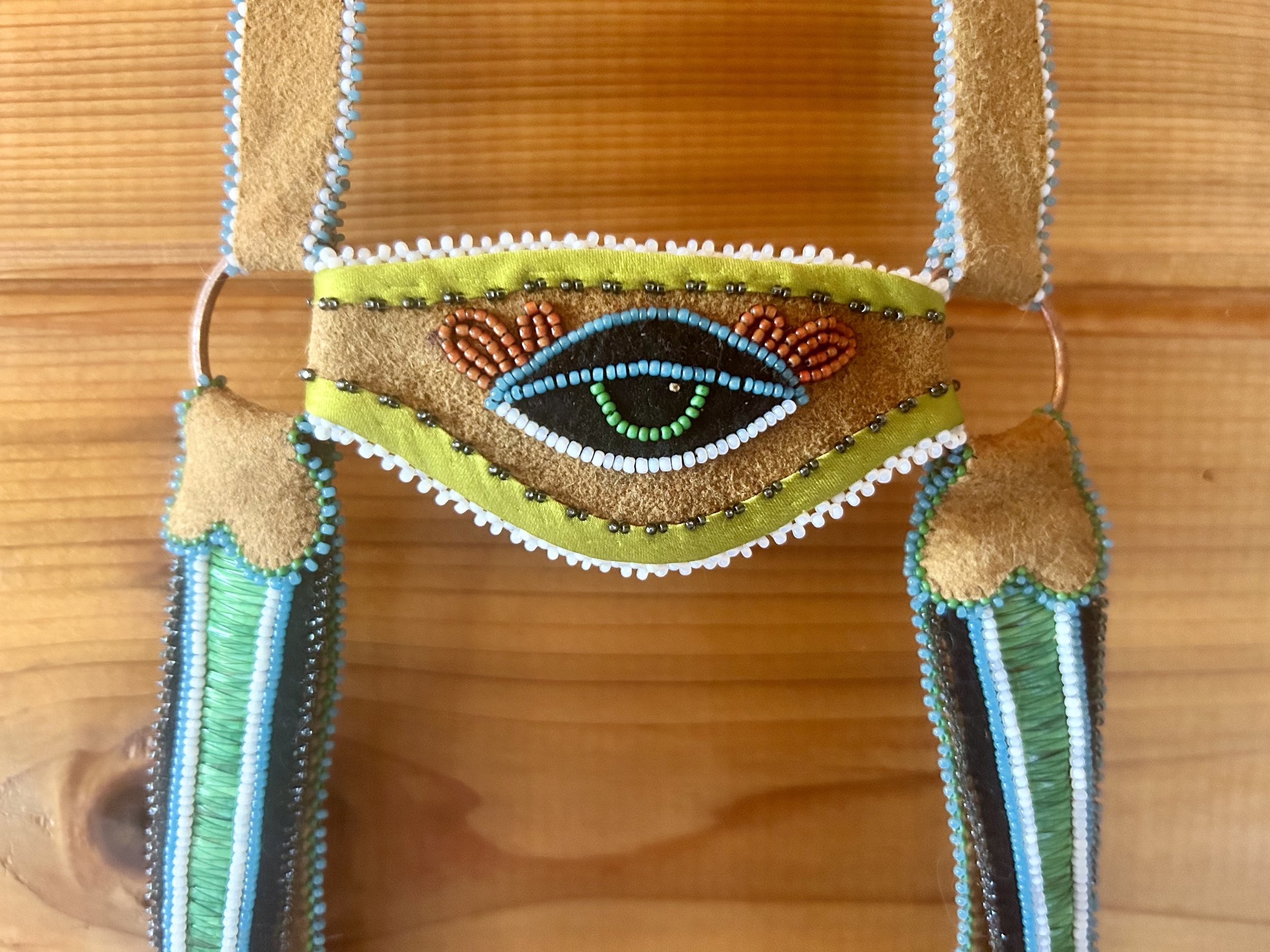 Headstall - 2024 - If worn by a horse, the eye would sit at the center of their forehead and medicine tabs at each temple. Worn by a human, these elements sit on the chest.