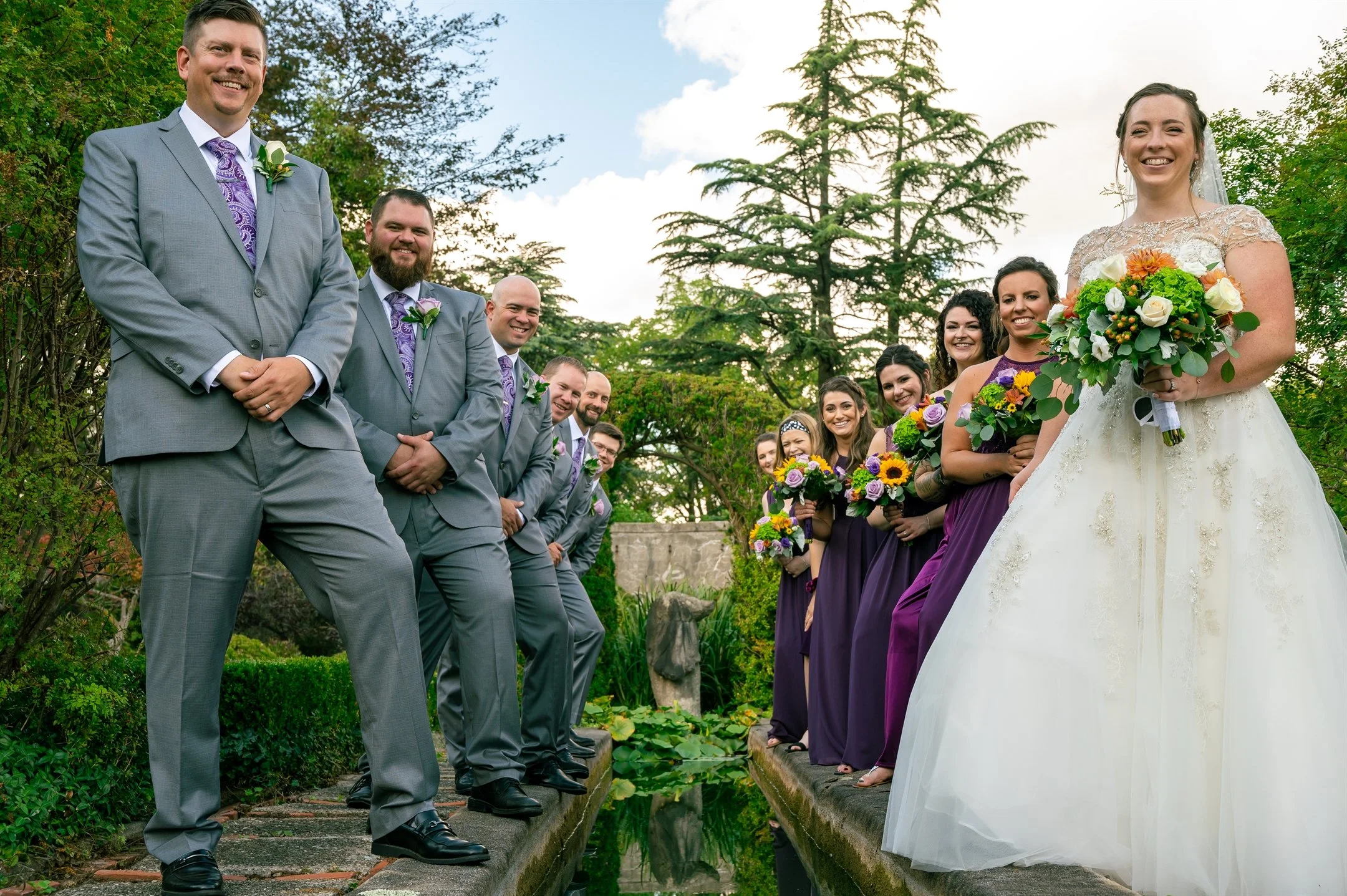 Bride and groom with wedding party in garden