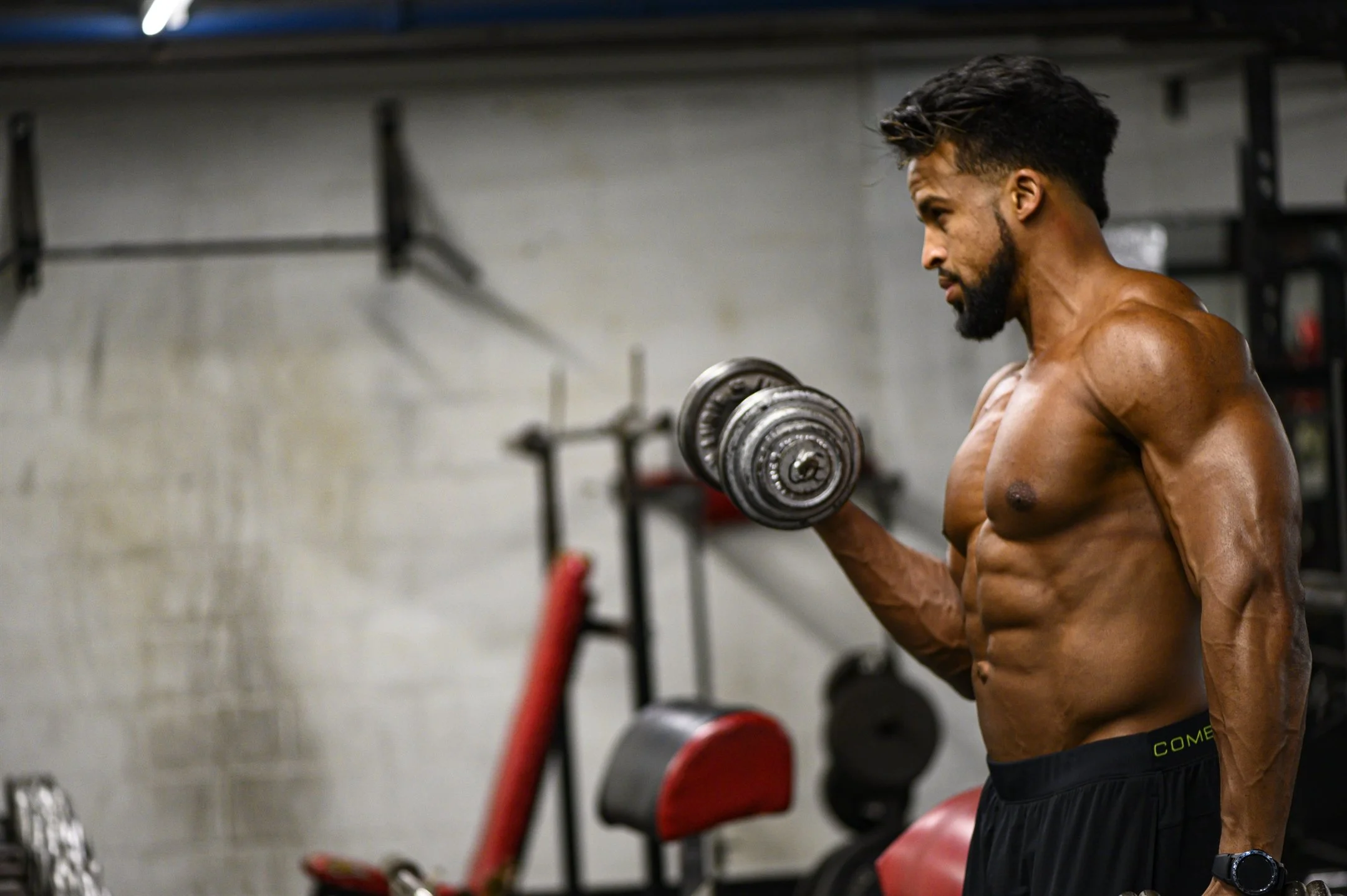 Man lifting dumbbells in a gym