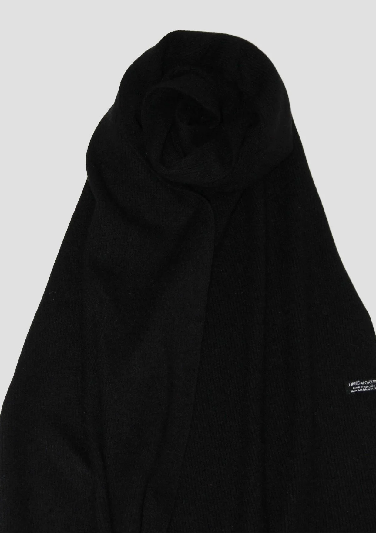 Shop a 100% Mongolian cashmere oversized scarf in black. Ultra-soft, lightweight and warm ribbed knit. Designed in Berlin and made in Mongolia by Hand of Origin.