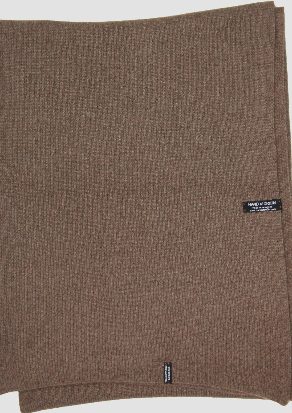 Shop a 100% Mongolian yak wool oversized scarf in natural brown. Warm and lightweight ribbed knit. Designed in Berlin and made in Mongolia by Hand of Origin.