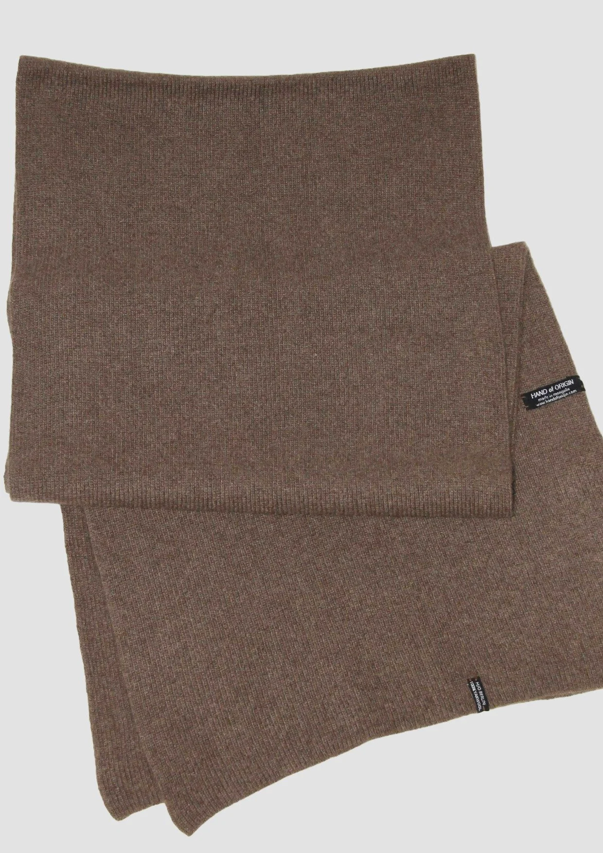 Shop a 100% Mongolian yak wool oversized scarf in natural brown. Warm and lightweight ribbed knit. Designed in Berlin and made in Mongolia by Hand of Origin.