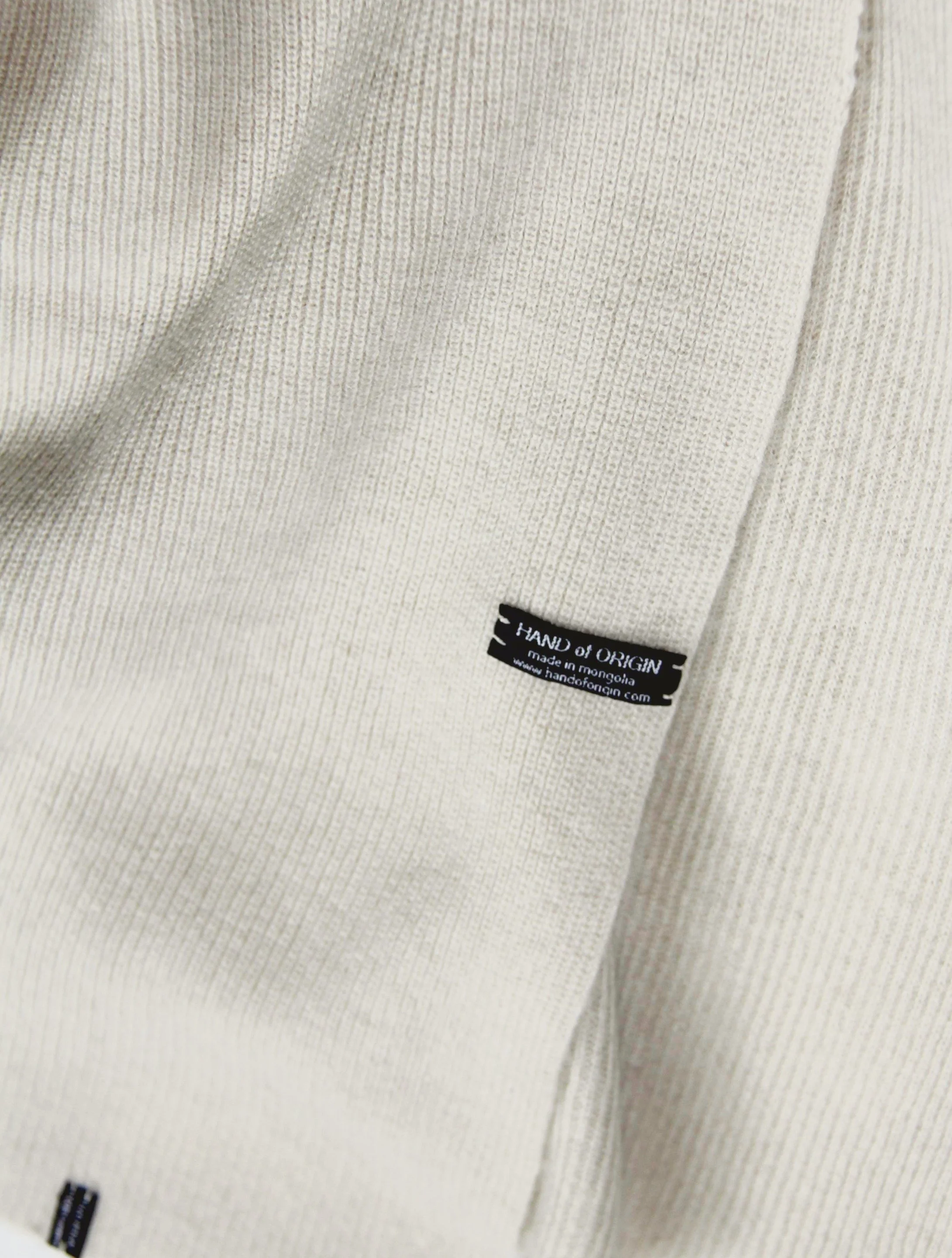 Shop 100% Mongolian cashmere oversized scarf in natural white. Ultra-soft, lightweight, and warm ribbed knit. Designed in Berlin and made in Mongolia by Hand of Origin.