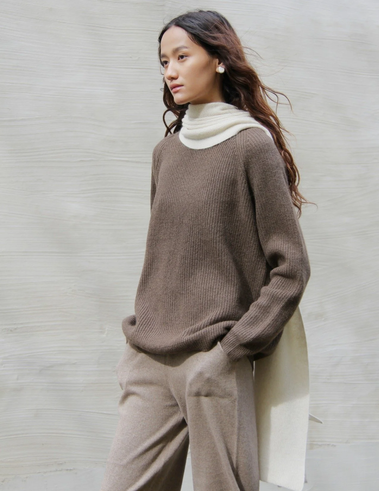 Shop 100% Mongolian cashmere oversized scarf in natural white. Ultra-soft, lightweight, and warm ribbed knit. Designed in Berlin and made in Mongolia by Hand of Origin.