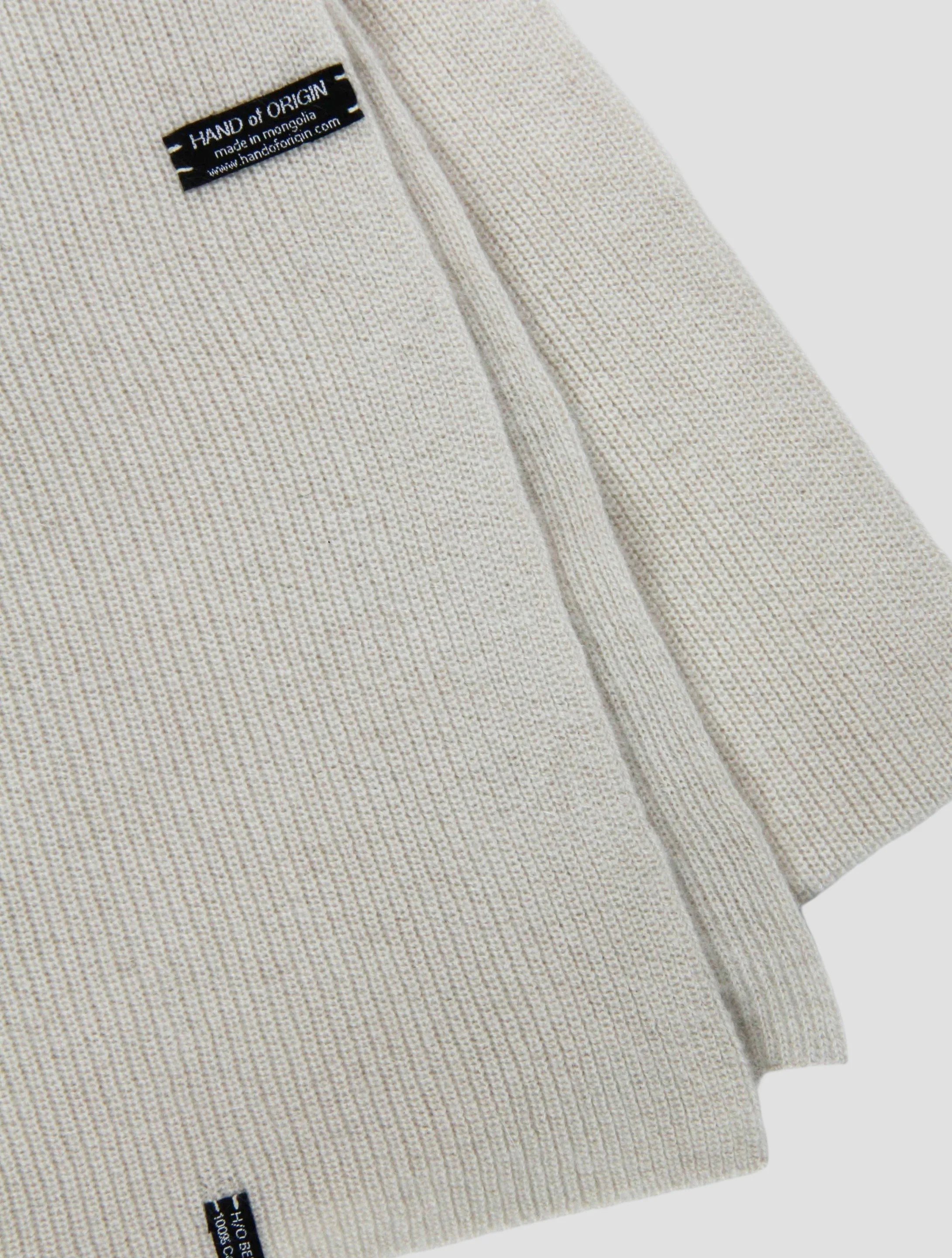 Shop 100% Mongolian cashmere oversized scarf in natural white. Ultra-soft, lightweight, and warm ribbed knit. Designed in Berlin and made in Mongolia by Hand of Origin.