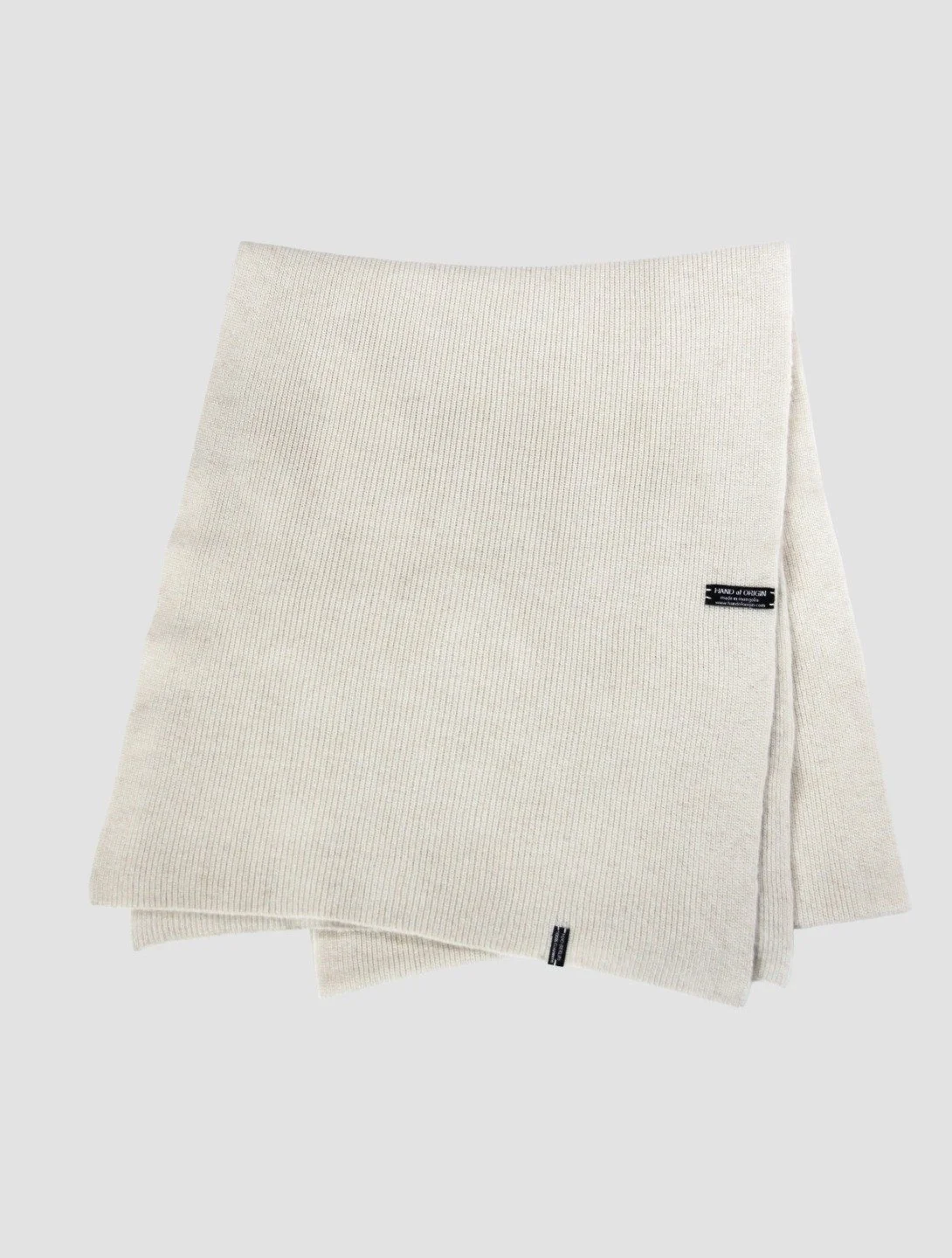 Shop 100% Mongolian cashmere oversized scarf in natural white. Ultra-soft, lightweight, and warm ribbed knit. Designed in Berlin and made in Mongolia by Hand of Origin.