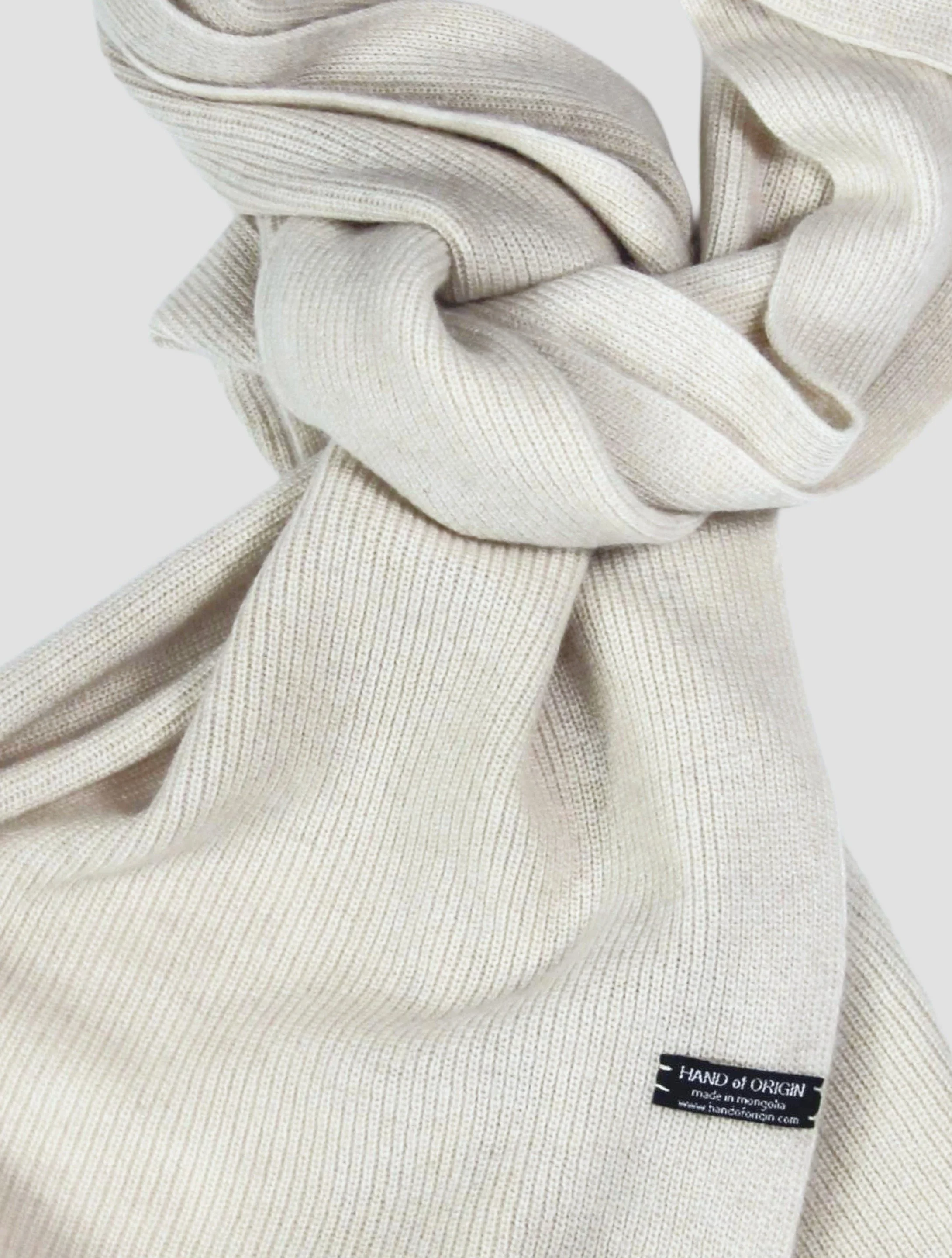 Shop 100% Mongolian cashmere oversized scarf in natural white. Ultra-soft, lightweight, and warm ribbed knit. Designed in Berlin and made in Mongolia by Hand of Origin.