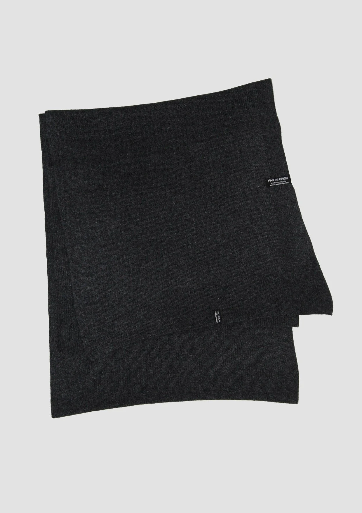 Shop a 100% Mongolian cashmere oversized scarf in anthracite. Ultra-soft, lightweight and warm ribbed knit. Designed in Berlin and made in Mongolia by Hand of Origin.