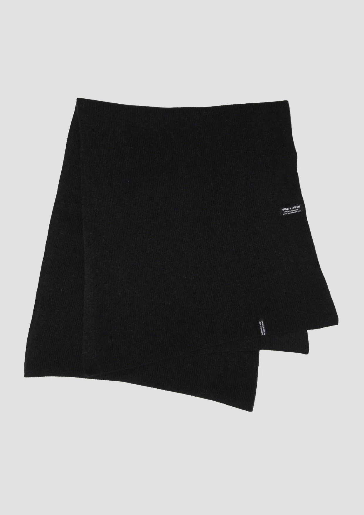 Shop a 100% Mongolian cashmere oversized scarf in black. Ultra-soft, lightweight and warm ribbed knit. Designed in Berlin and made in Mongolia by Hand of Origin.