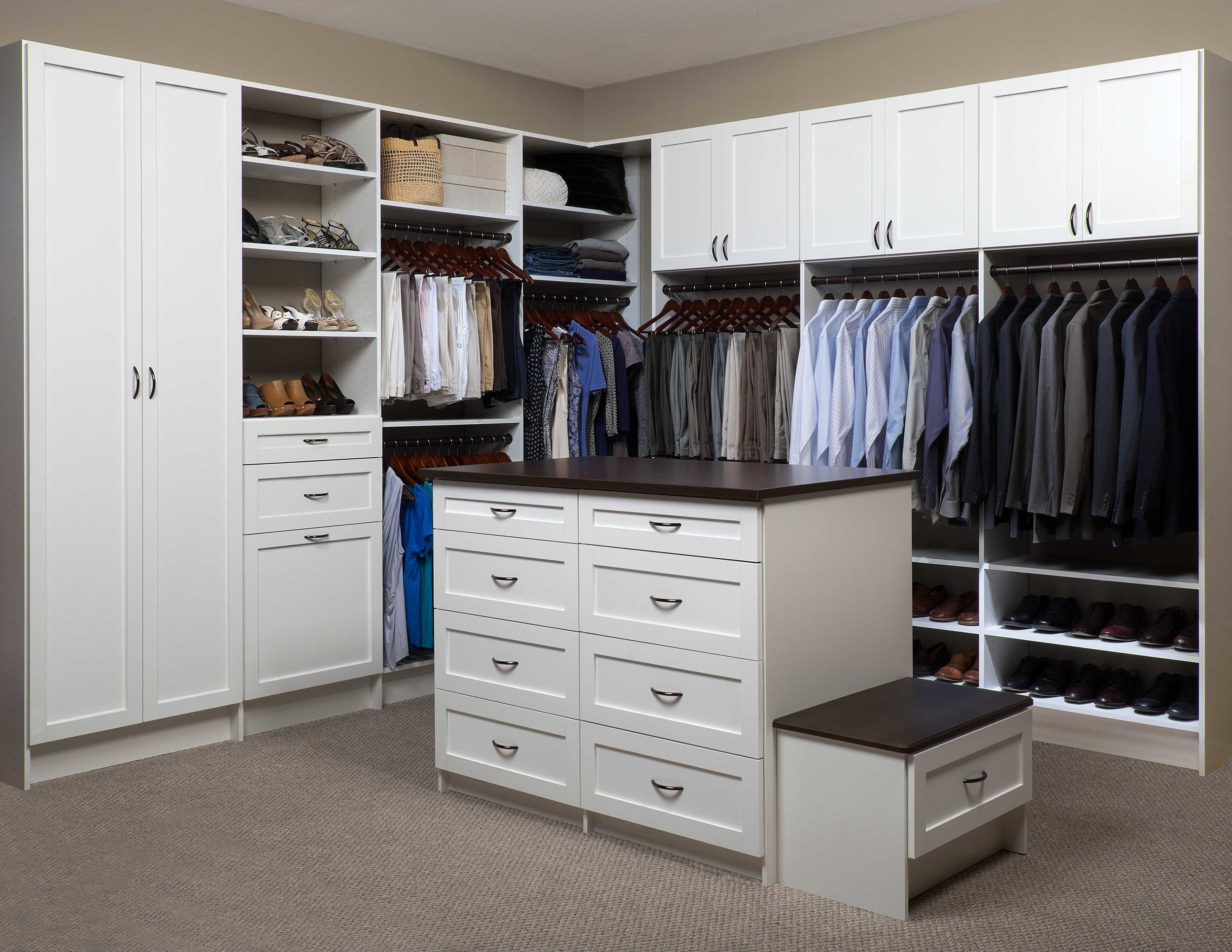 walk in closet with matching white colored wood closet organizers