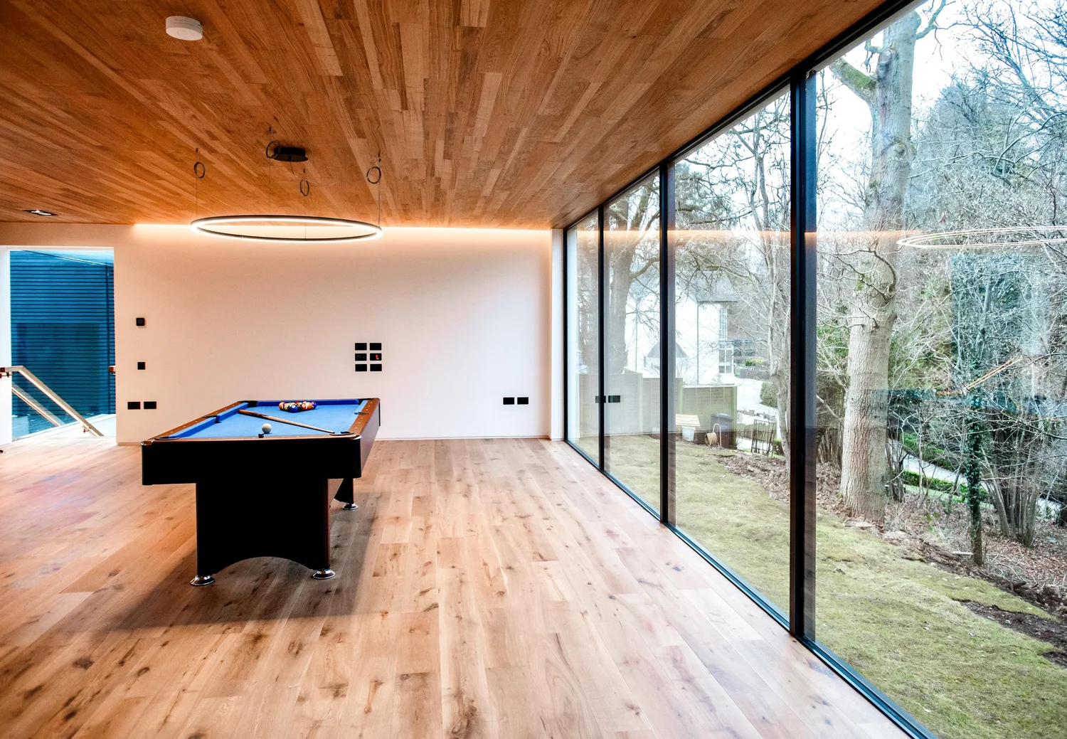 Living space with oak ceiling and full height glazing
