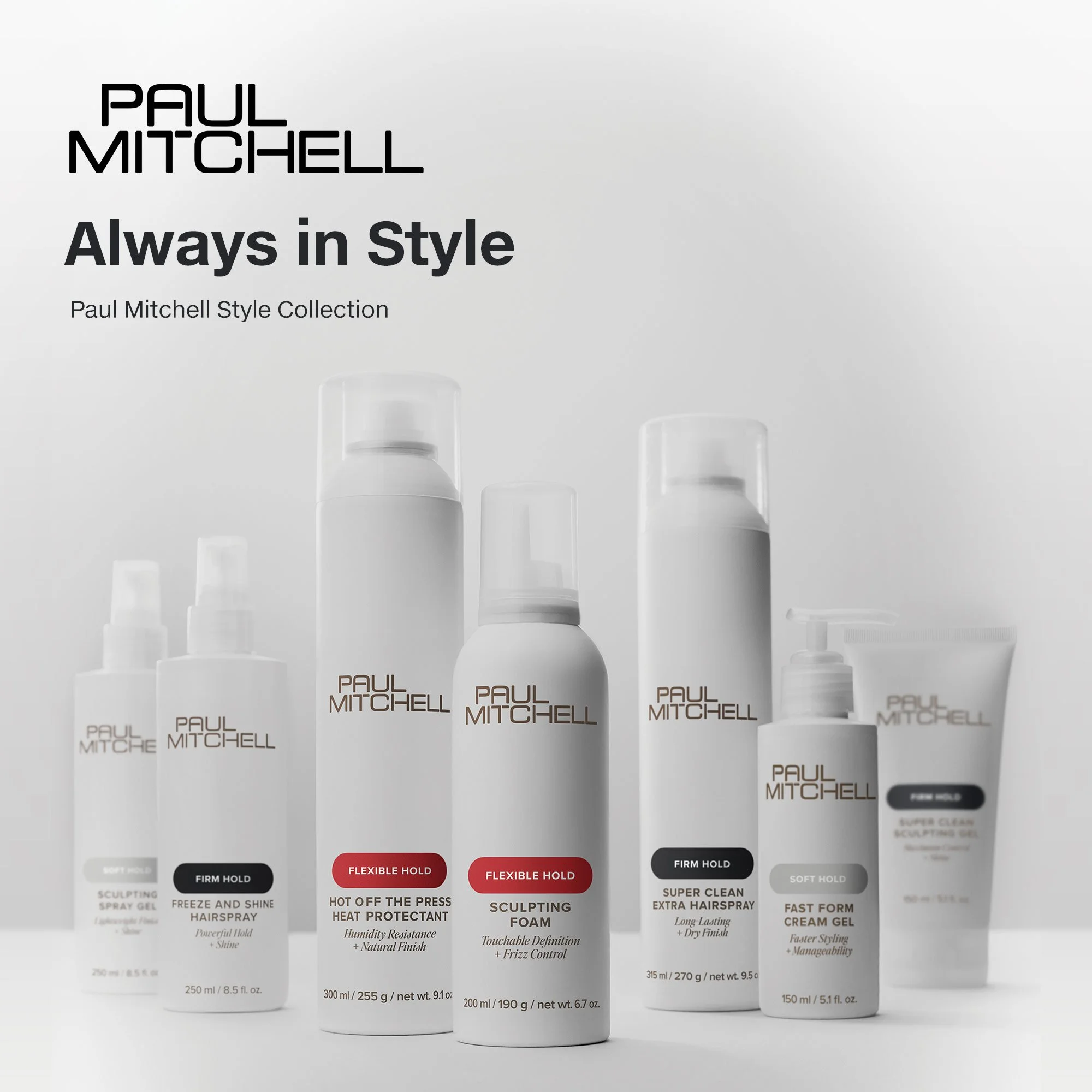 Collection of Paul Mitchell hair care products including spray, foam, hairspray, and gel bottles, with a light gray background.