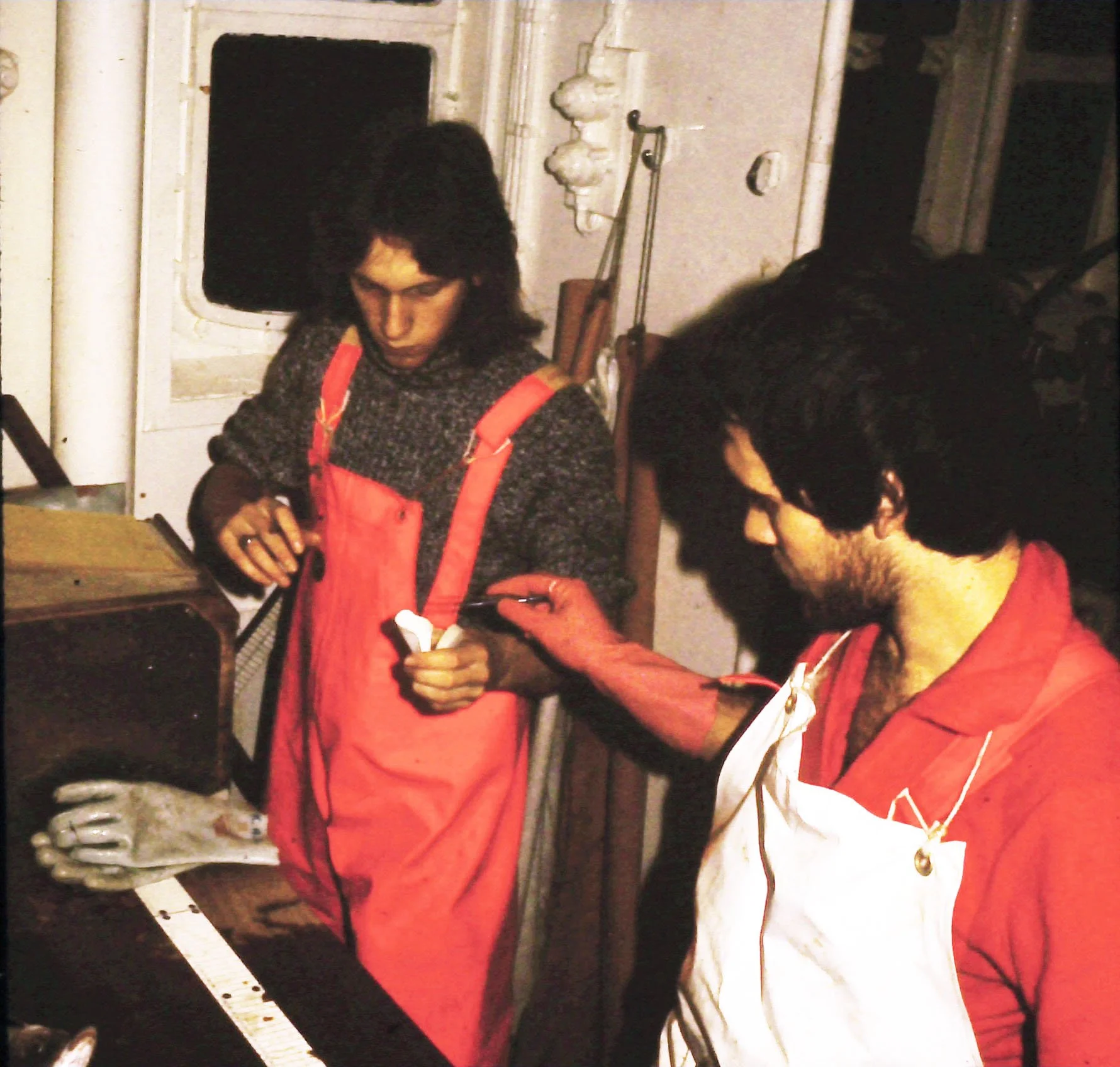 Scientists in fish house taking oitliths (ear bones from fish for age determination)