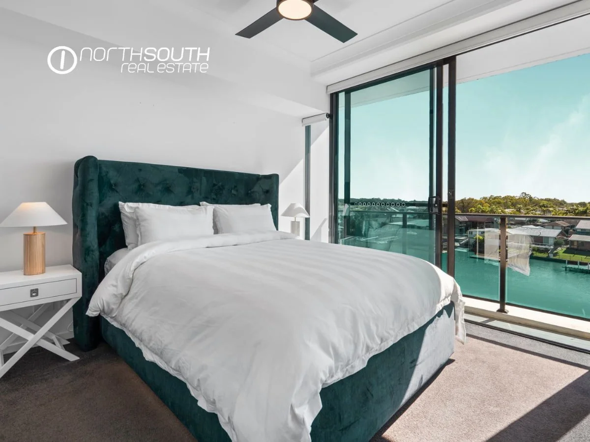 Spacious master bedroom with balcony overlooking water views at Waterpoint Residences 3303/5 Harbourside Ct , Biggera Waters QLD.