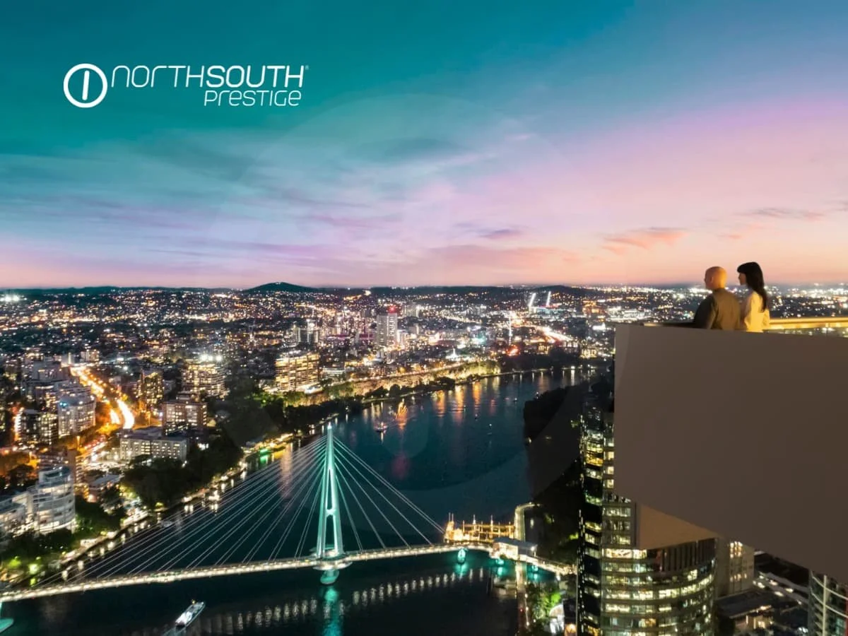 A couple on the balcony looking at twilight views of Brisbane City and the Kangaroo Point bridge - Brisbane properties for sale Riparian Plaza apartment 4903 
