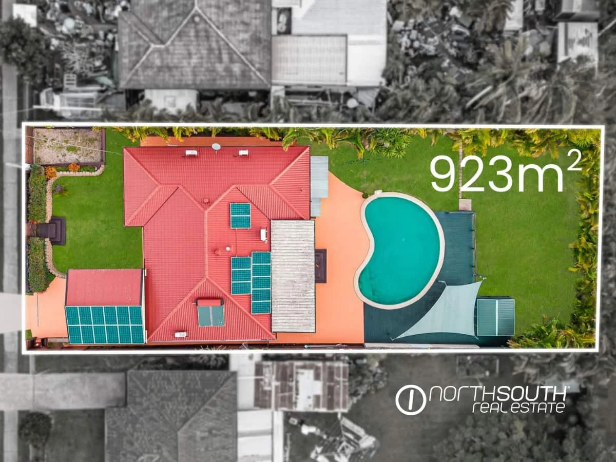 Aerial view of the house with solar panels on the roof, pool and backyard at 7 Bligh Street, Rochedale South QLD 4123