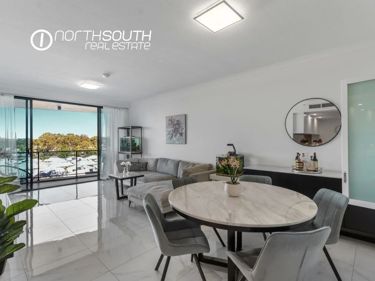 Spacious living and dining zone with tiled floors flowing to balcony at 3409 5 Harbourside Ct Waterpoint Residences, Biggera Waters QLD. 