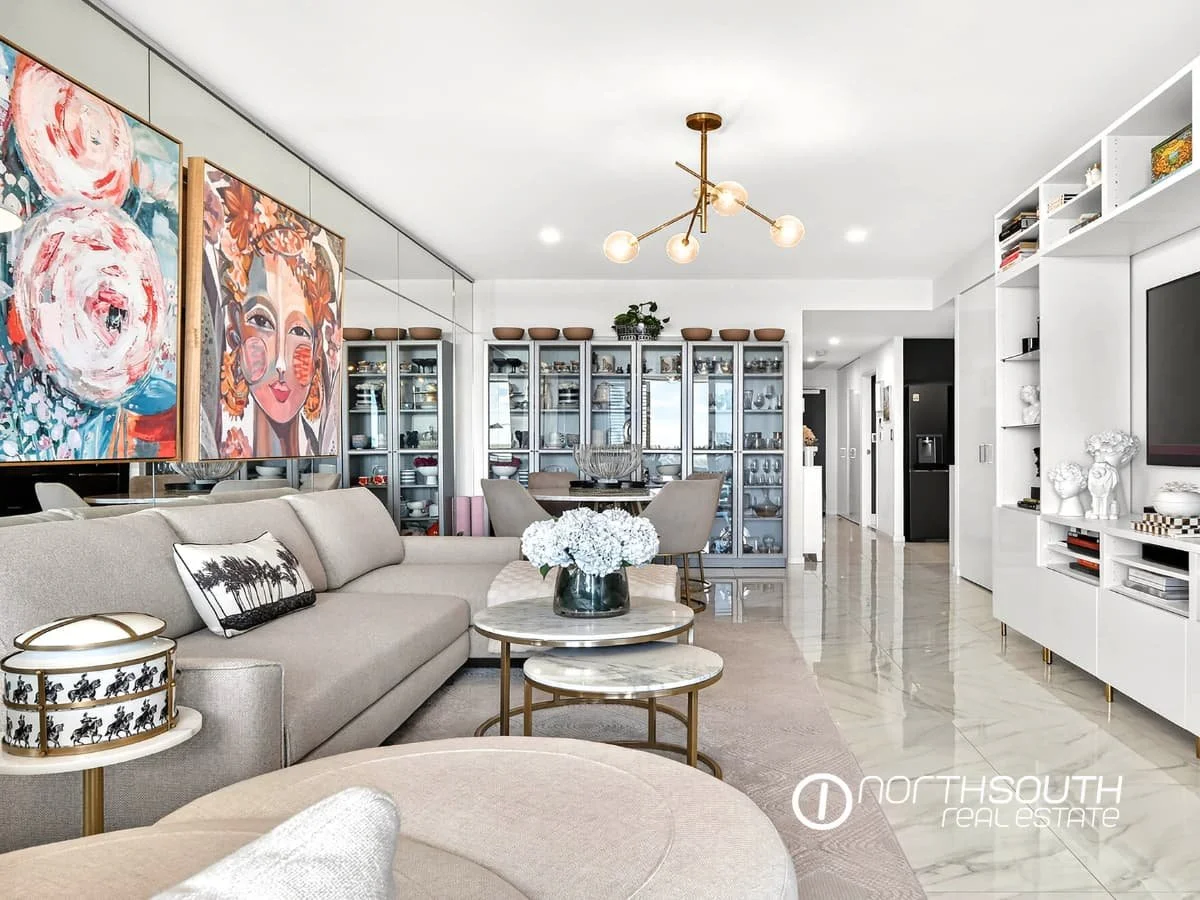 Spacious living and dining zone with tiled floors and designer furniture at 4705 Waterpoint Residences, Biggera Waters QLD. 