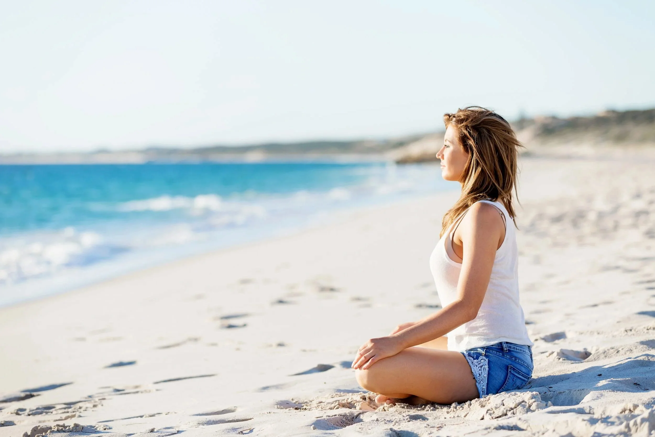 A woman relaxing alone on a quiet beach