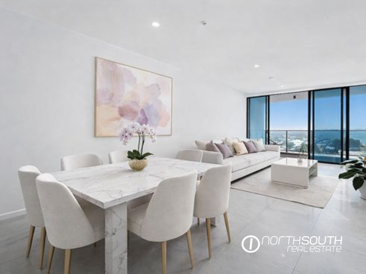 Dining area with expansive water views at Waterpoint apartment 5104