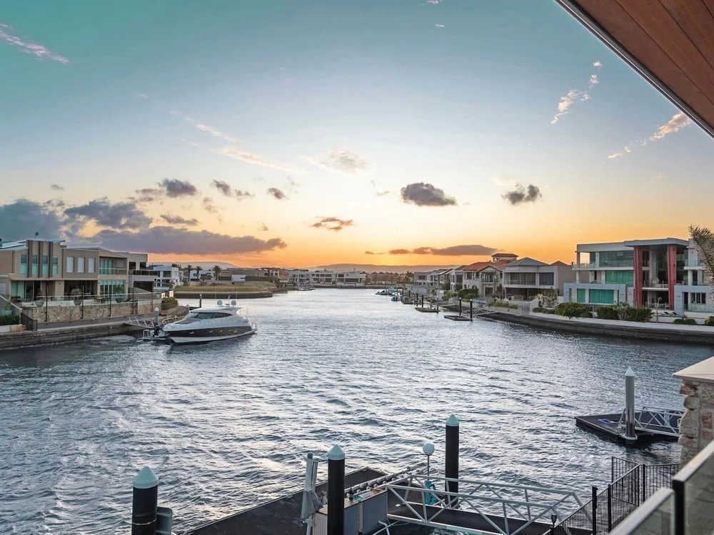 Sovereign Islands luxury homes and yachts at twilight, showcasing property strategies for wealth building in Australia