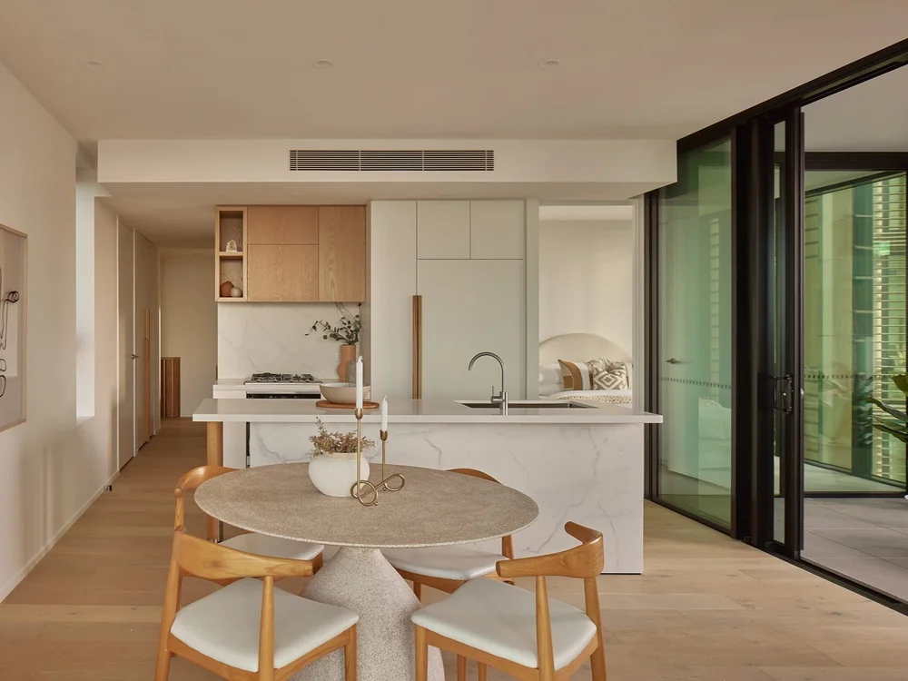 Lounge and kitchen area with city views in luxury Brisbane apartment at 443 Queen St in properties for sale