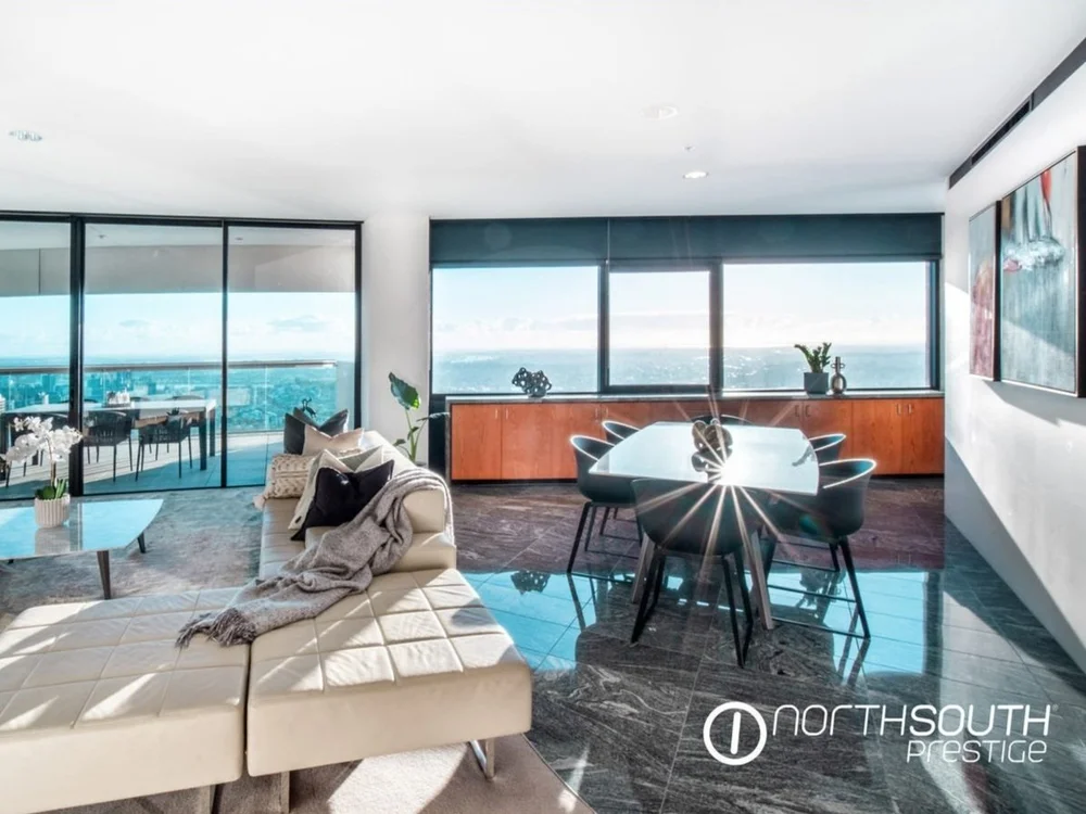 Open-plan living and dining room with floor-to-ceiling windows and long city views at 4503/71 Eagle Street, Riparian Plaza