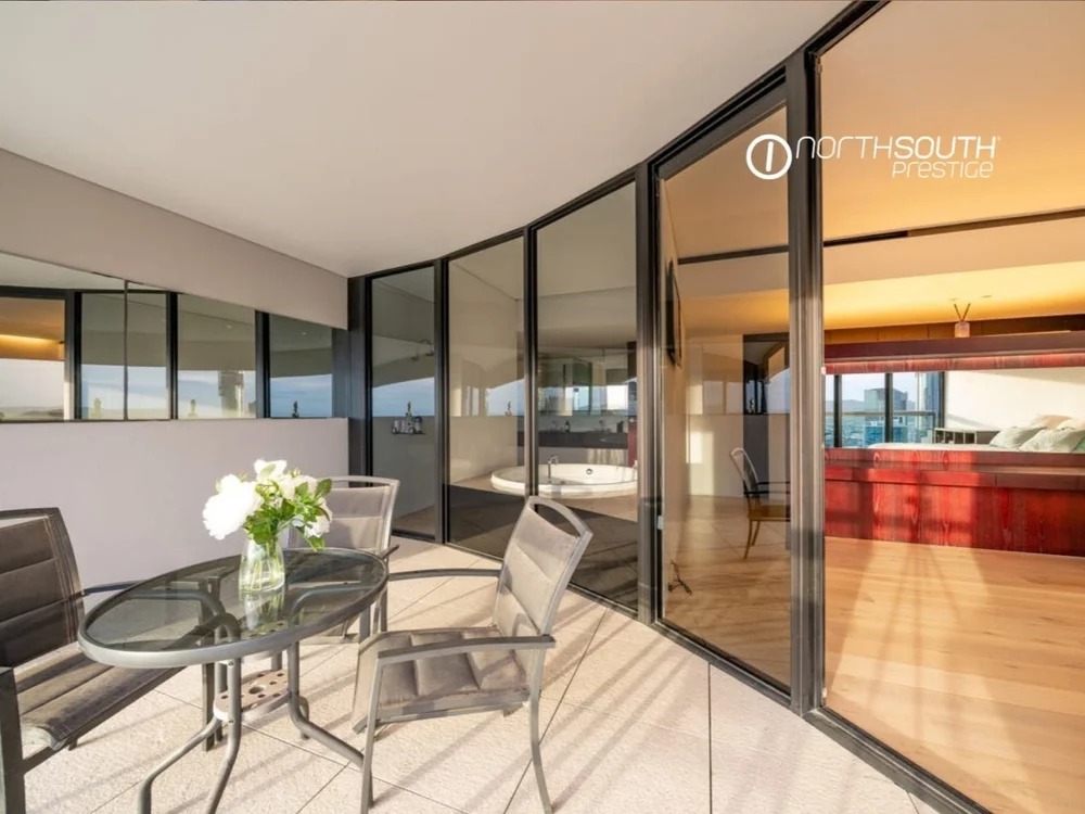 Balcony seating and open plan living – Brisbane properties for sale Riparian Plaza apartment