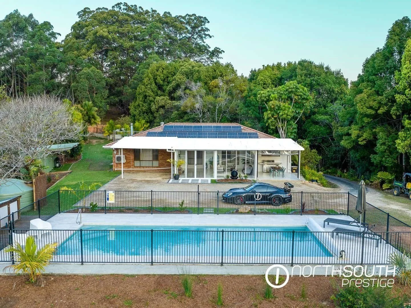 Aerial drone shot of the pool and house at properties for sale northern nsw nobbys creek 100 acres.