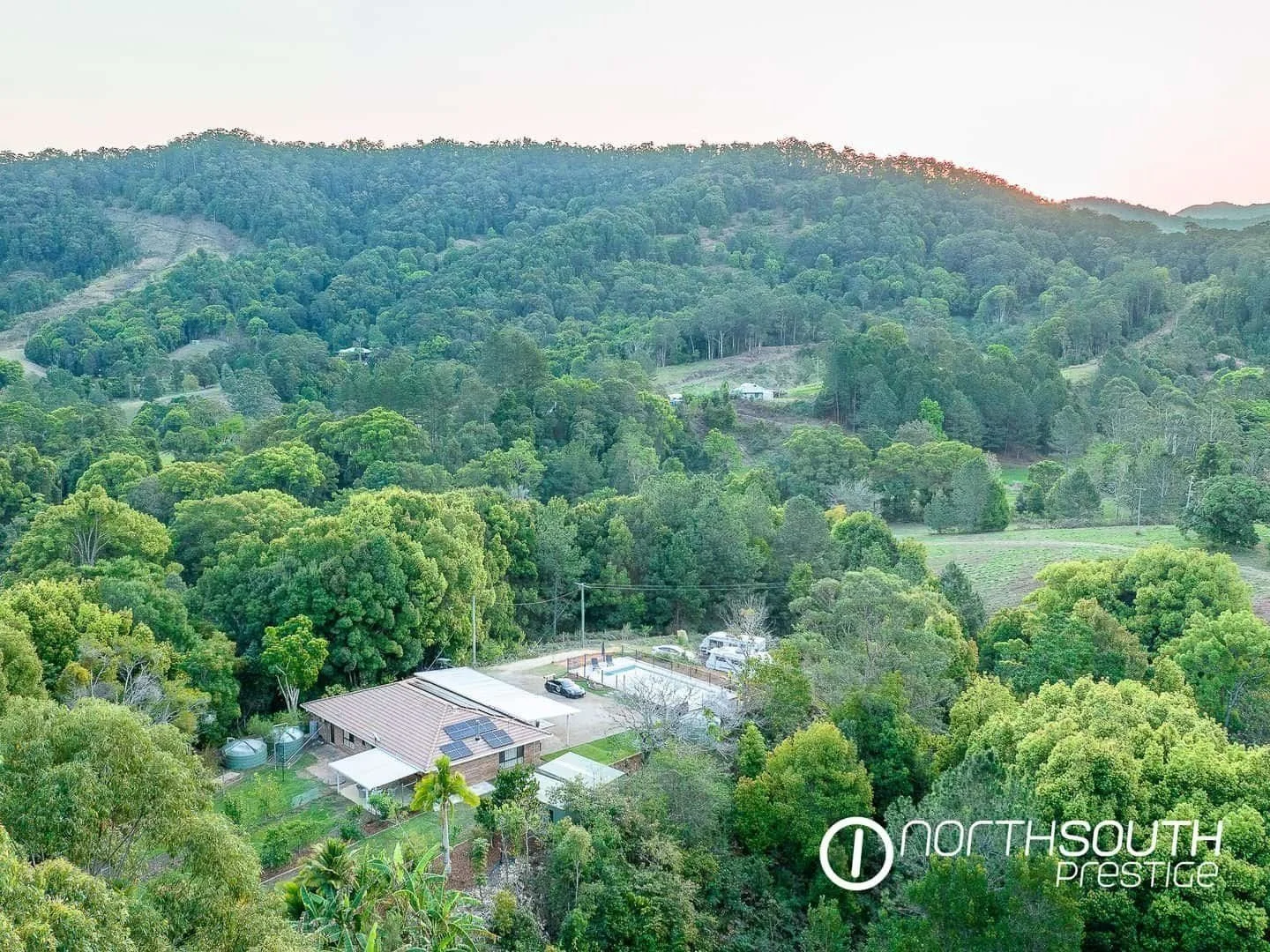 Aerial drone footage of the back of the house at properties for sale northern nsw nobbys creek 100 acres.