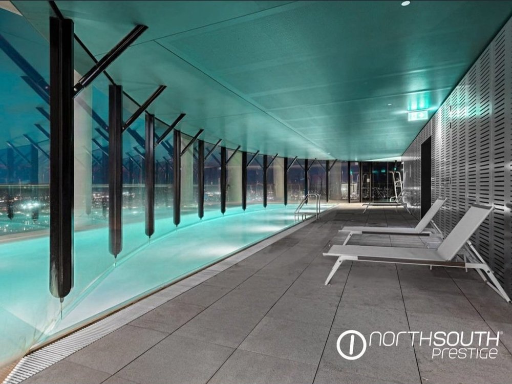 Pool lit at night at properties for sale Brisbane riparian plaza apartment 4202.