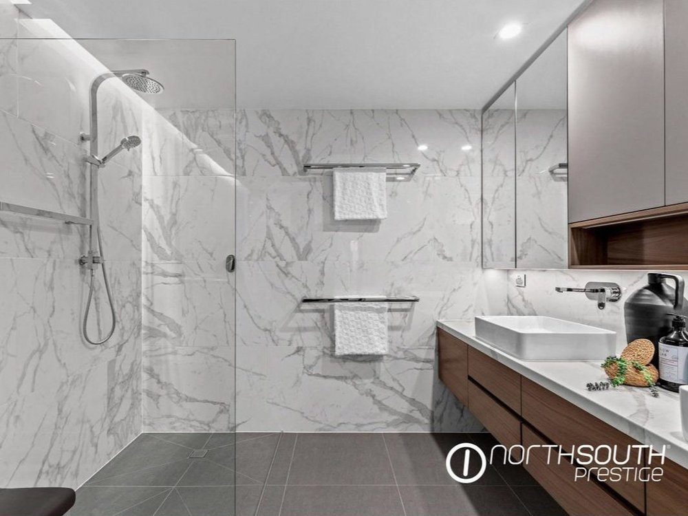 Bathroom with stone finishes at properties for sale Brisbane riparian plaza apartment 4202.